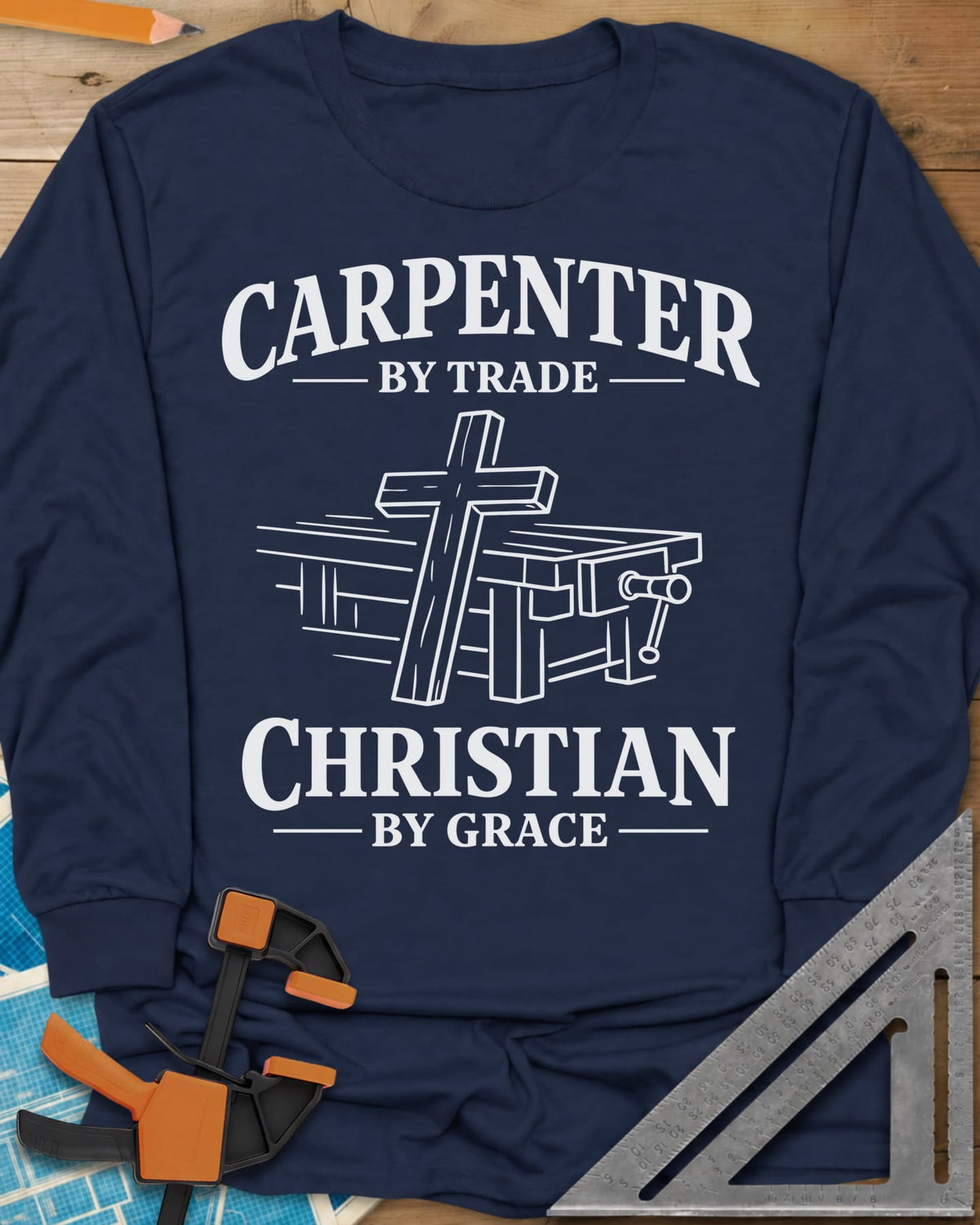 Carpenter by Trade long sleeve shirt in Navy, a wooden cross leaning against a workbench with a vise