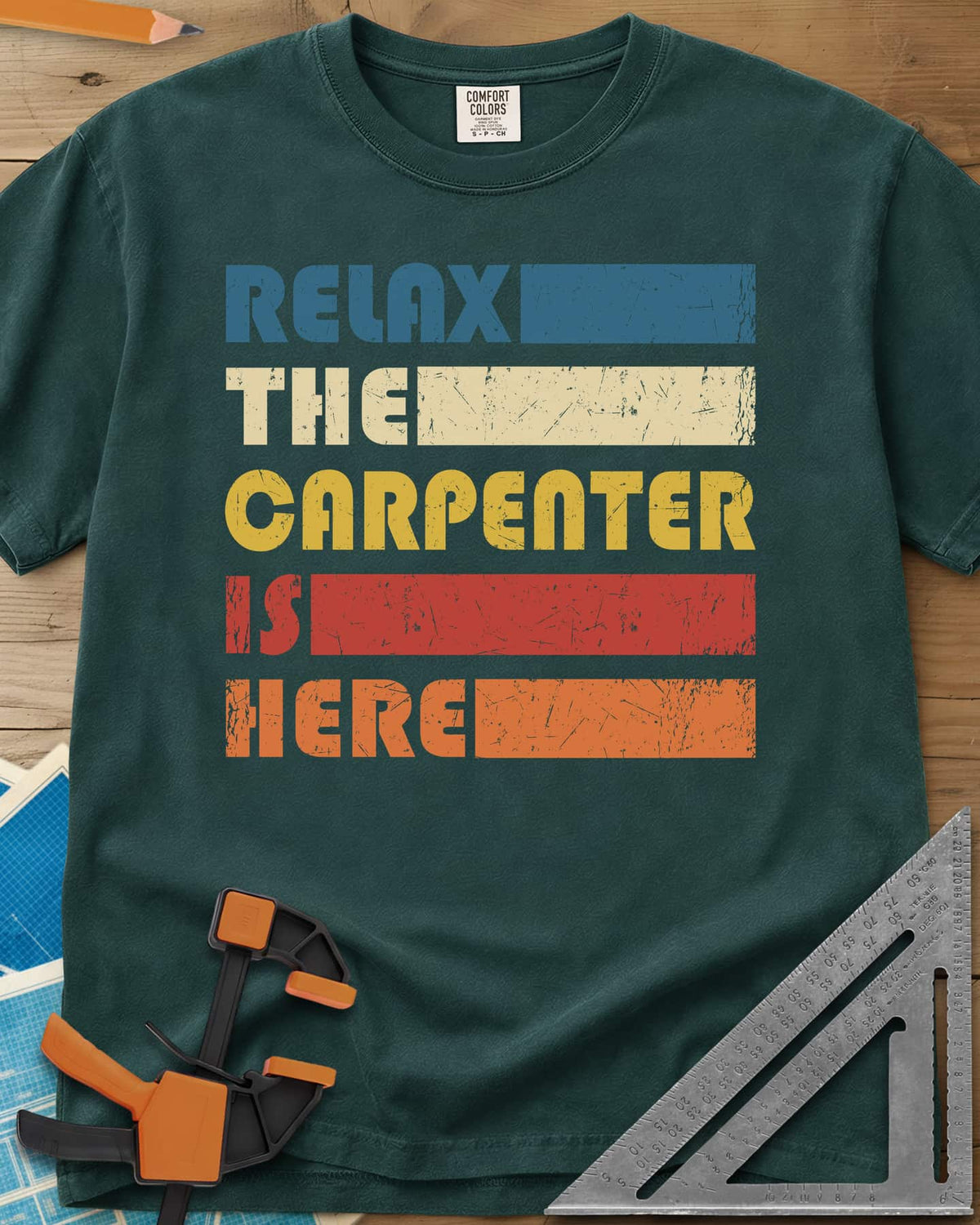Carpenter is Here heavyweight tee in Blue Spruce, retro stacked lettering with solid color bars in five colors