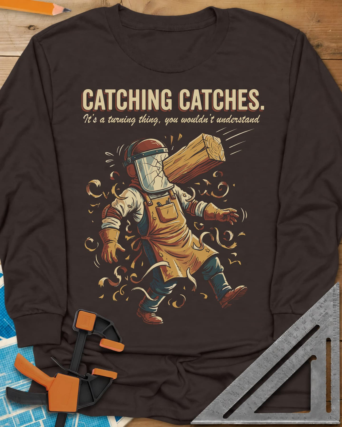 Catching Catches long sleeve shirt in Dark Chocolate, a turner in a cracked face shield and a flying chunk of wood