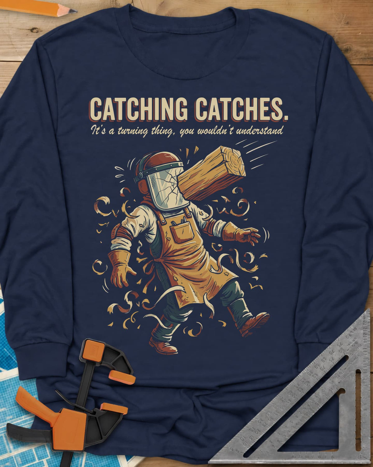 Catching Catches long sleeve shirt in Navy, a turner in a cracked face shield and a flying chunk of wood