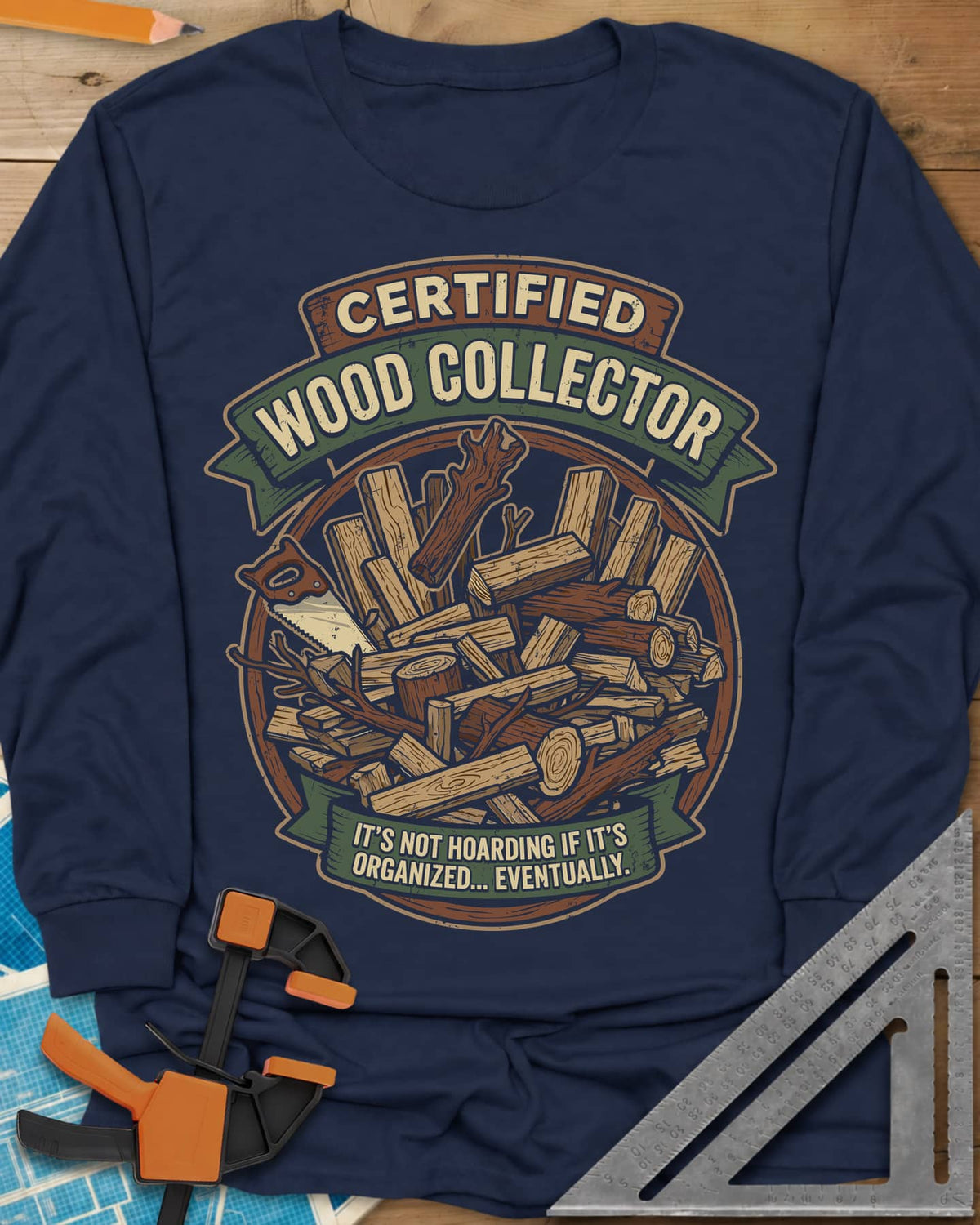 Certified Wood Collector long sleeve shirt in Navy, ribbon banners over a heap of logs, offcuts and a handsaw