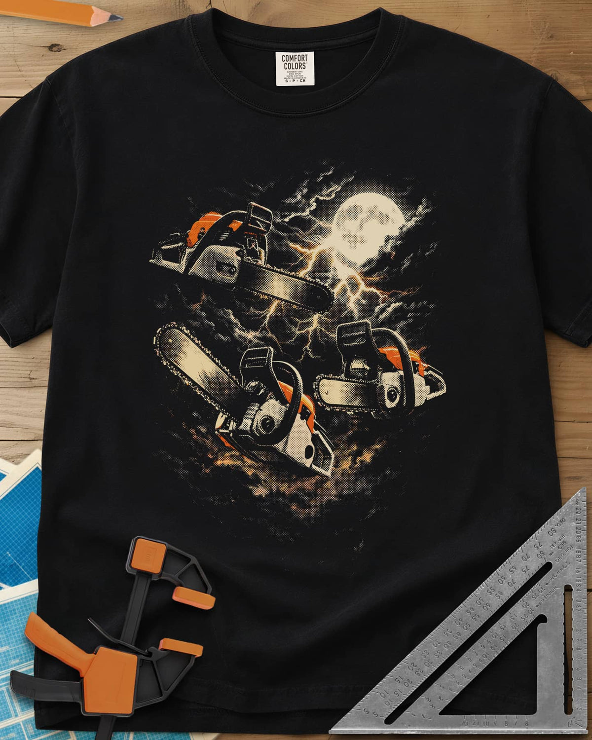 Chainsaw After Dark heavyweight tee in Black, three chainsaws floating under a full moon and lightning