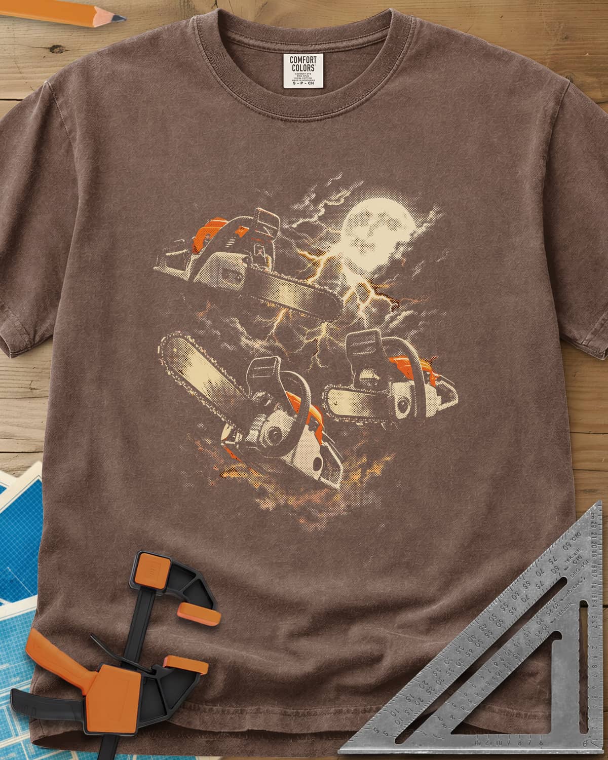 Chainsaw After Dark heavyweight tee in Espresso, three chainsaws floating under a full moon and lightning