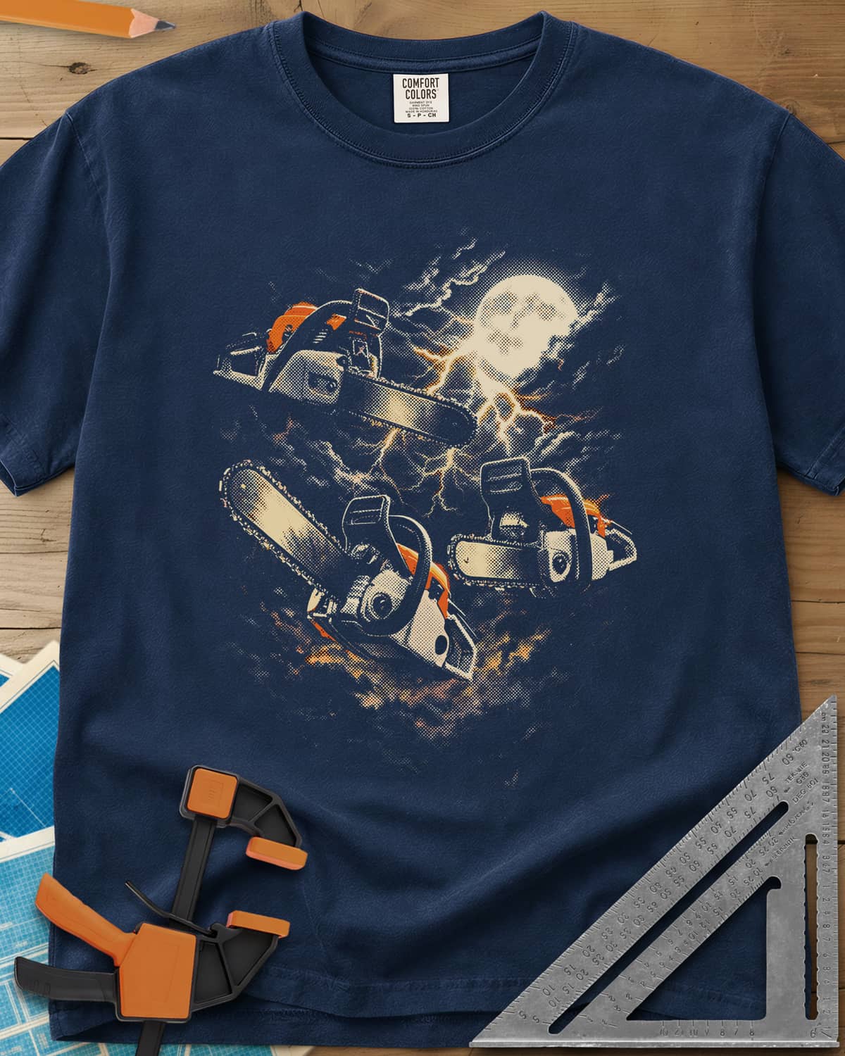 Chainsaw After Dark heavyweight tee in Navy, three chainsaws floating under a full moon and lightning