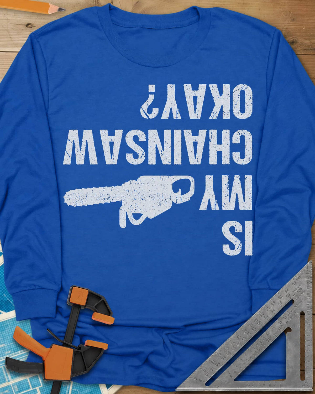 Chainsaw Okay? long sleeve shirt in Royal, upside-down distressed lettering beside a chainsaw on its side