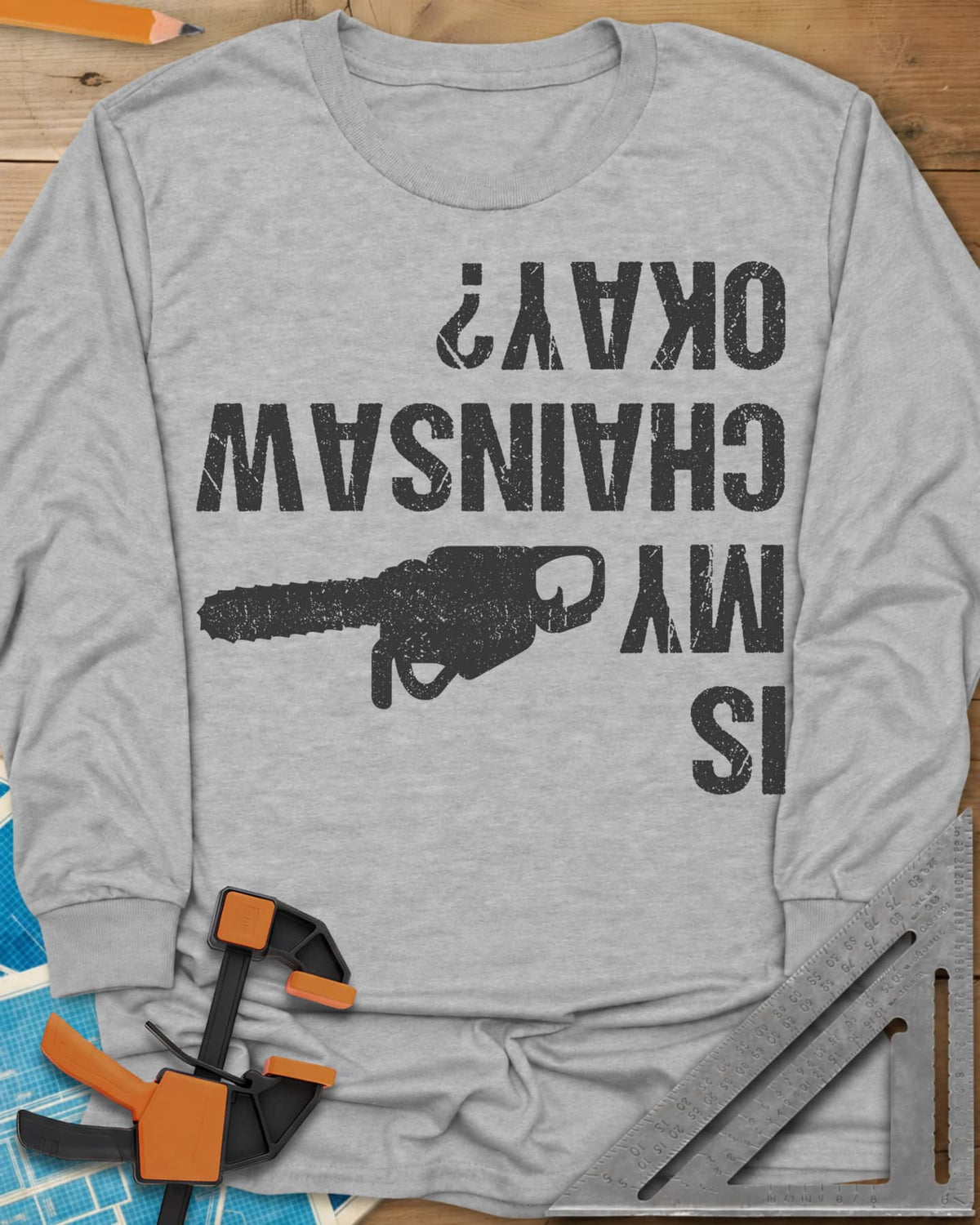 Chainsaw Okay? long sleeve shirt in Sport Grey, upside-down distressed lettering beside a chainsaw on its side