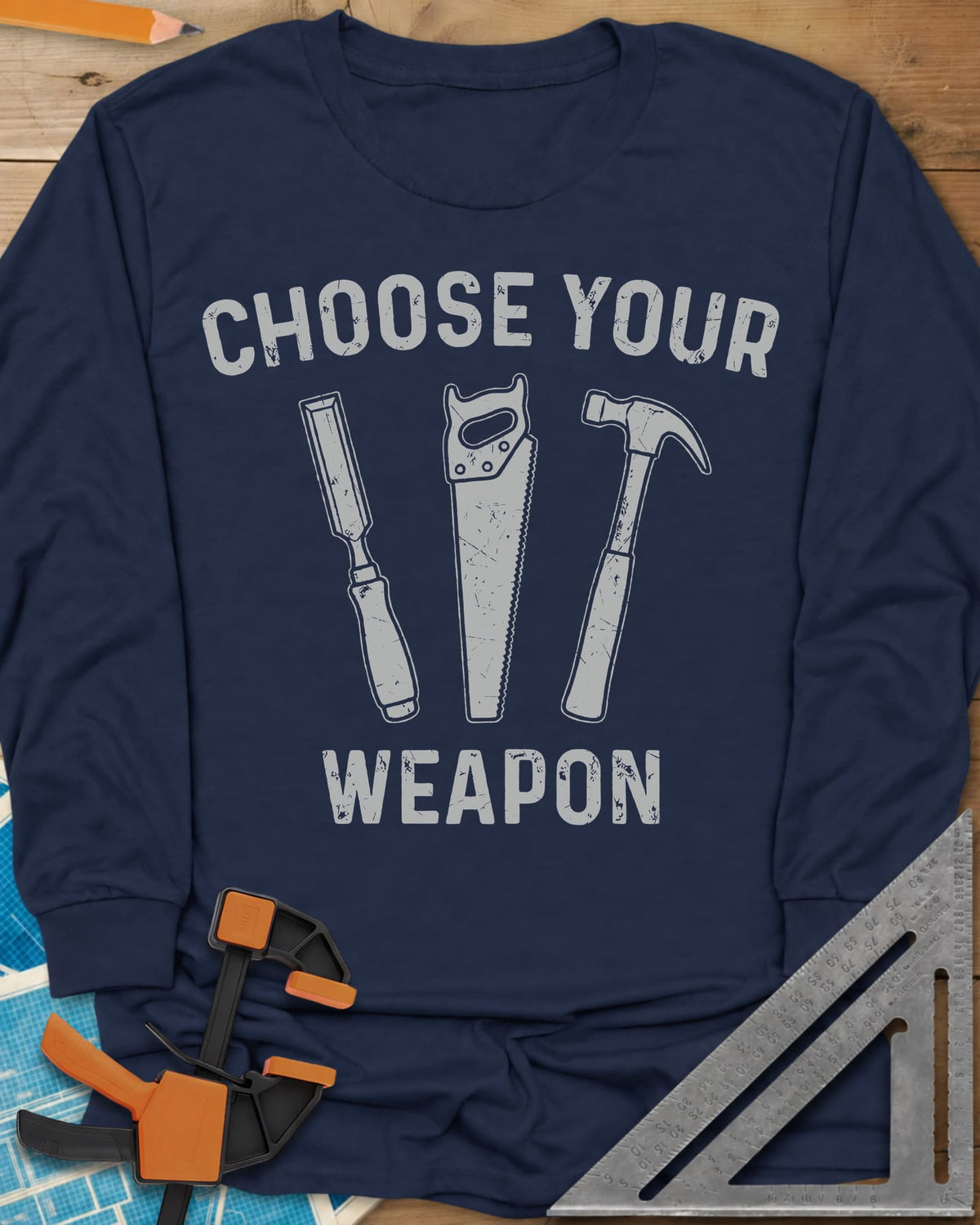 Choose Your Weapon long sleeve shirt in Navy, a chisel, a handsaw and a claw hammer standing in a row