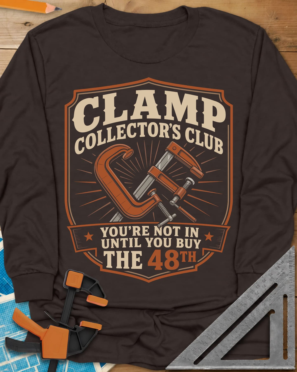 Clamp Collectors Club 48th long sleeve shirt in Dark Chocolate, a shield badge with a C-clamp and a bar clamp over a sunburst