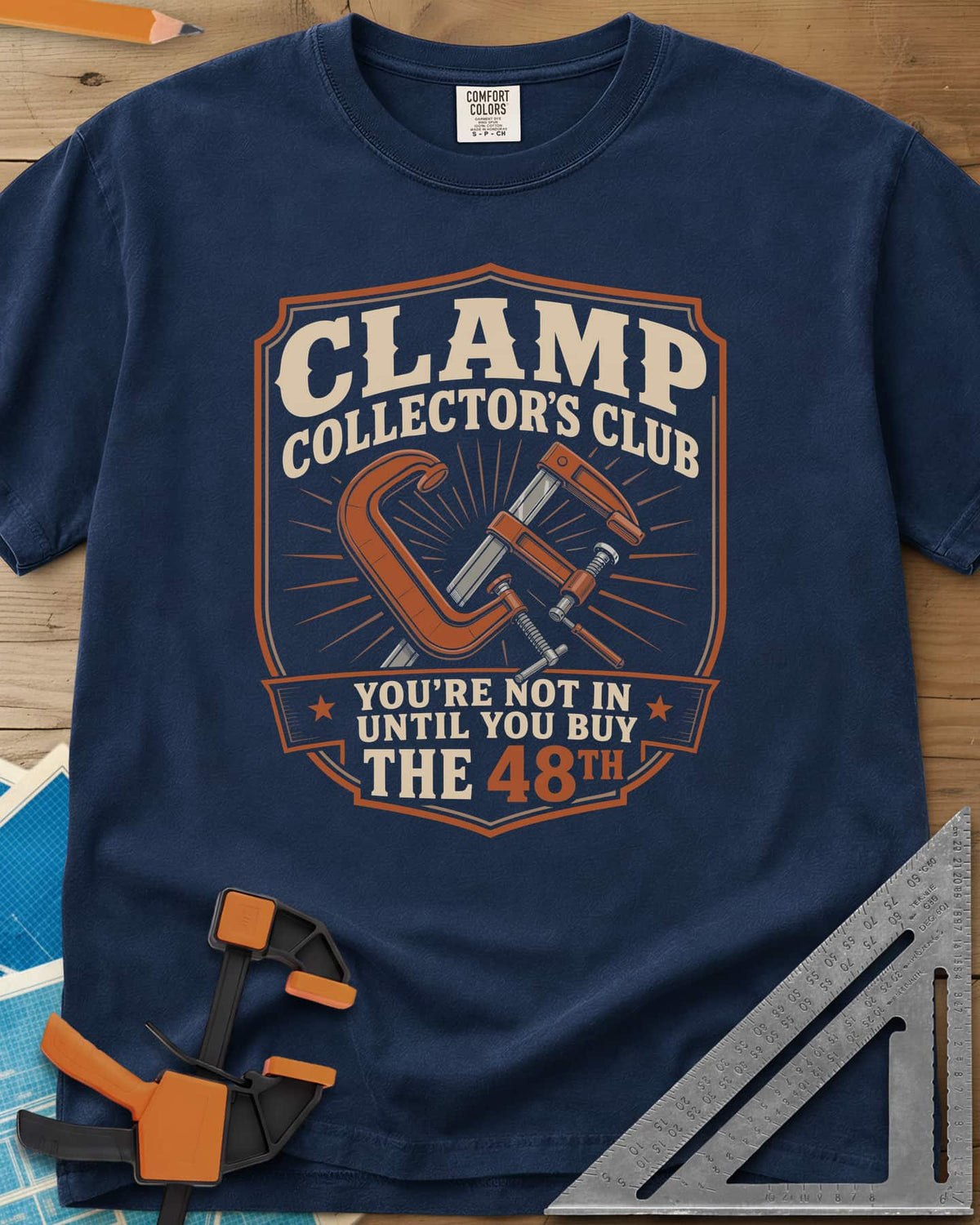 Clamp Collectors Club 48th heavyweight tee in Navy, a shield badge with a C-clamp and a bar clamp over a sunburst