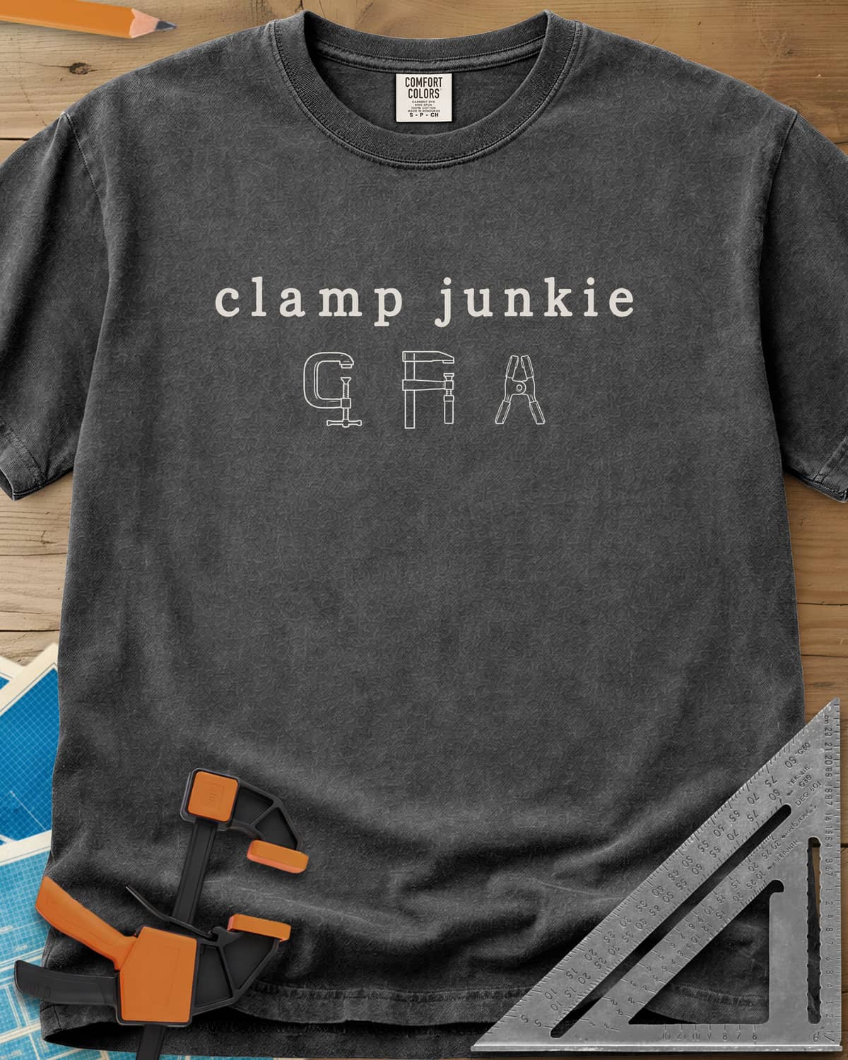 Clamp Junkie heavyweight tee in Pepper, outline drawings of a C-clamp, a bar clamp and a spring clamp