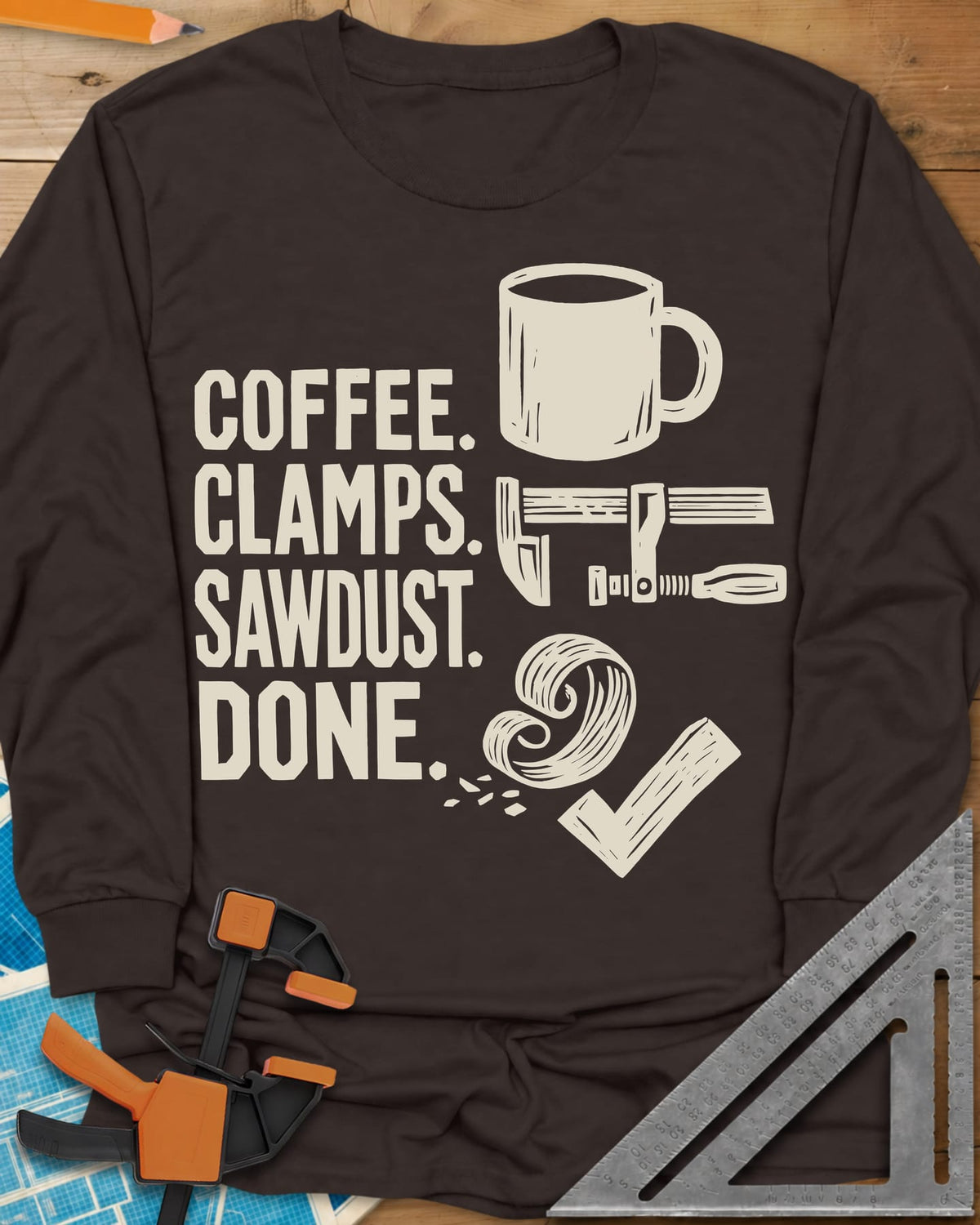 Coffee Clamps long sleeve shirt in Dark Chocolate, a mug, a bar clamp, a wood shaving curl and a check mark