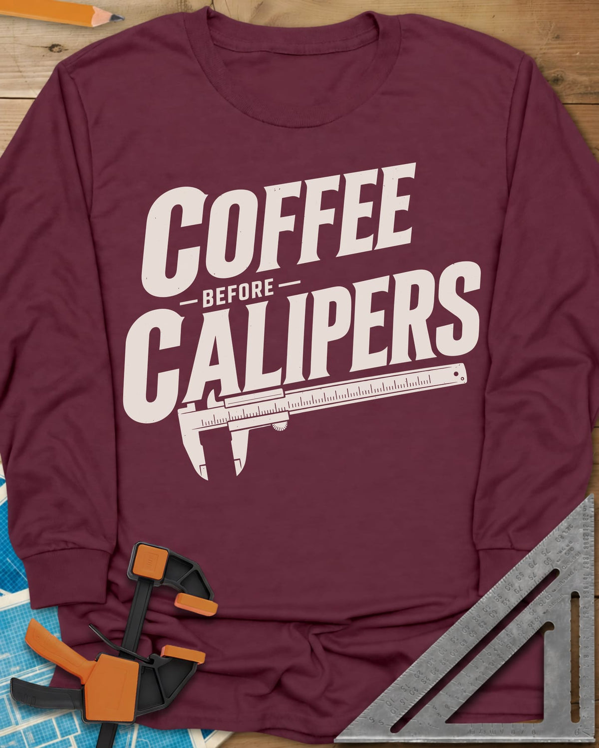 Coffee First long sleeve shirt in Maroon, bold slanted lettering with an orange vernier caliper below