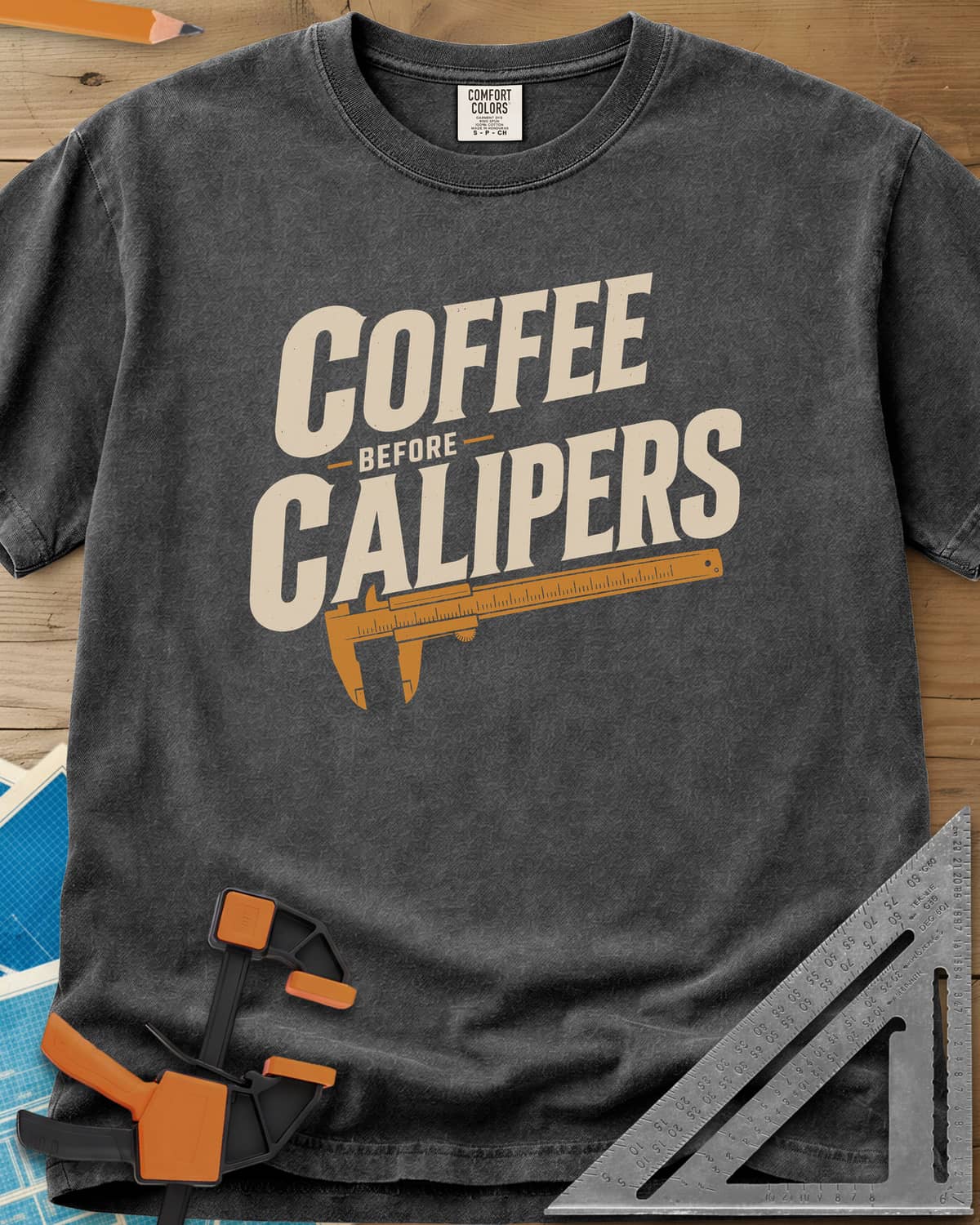 Coffee First heavyweight tee in Pepper, bold slanted lettering with an orange vernier caliper below