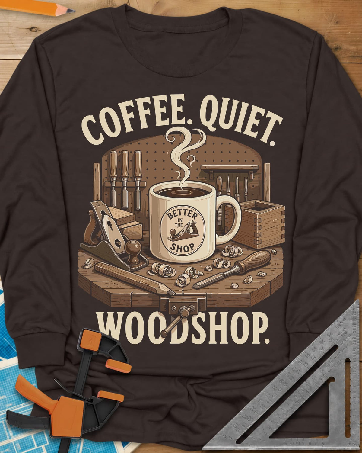 Coffee. Quiet. Woodshop. long sleeve shirt in Dark Chocolate, steaming mug on a workbench with chisels, a plane and wood