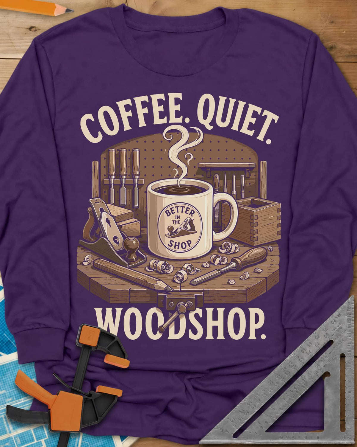 Coffee. Quiet. Woodshop. long sleeve shirt in Purple, steaming mug on a workbench with chisels, a plane and wood curls