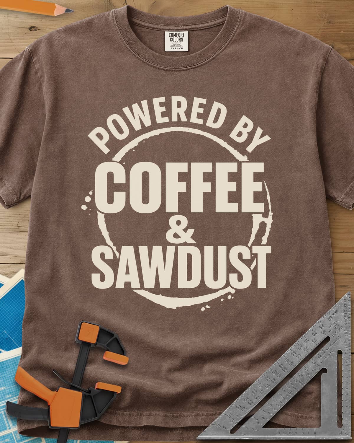 Coffee & Sawdust heavyweight tee in Espresso, stacked lettering inside a brown coffee-ring stain