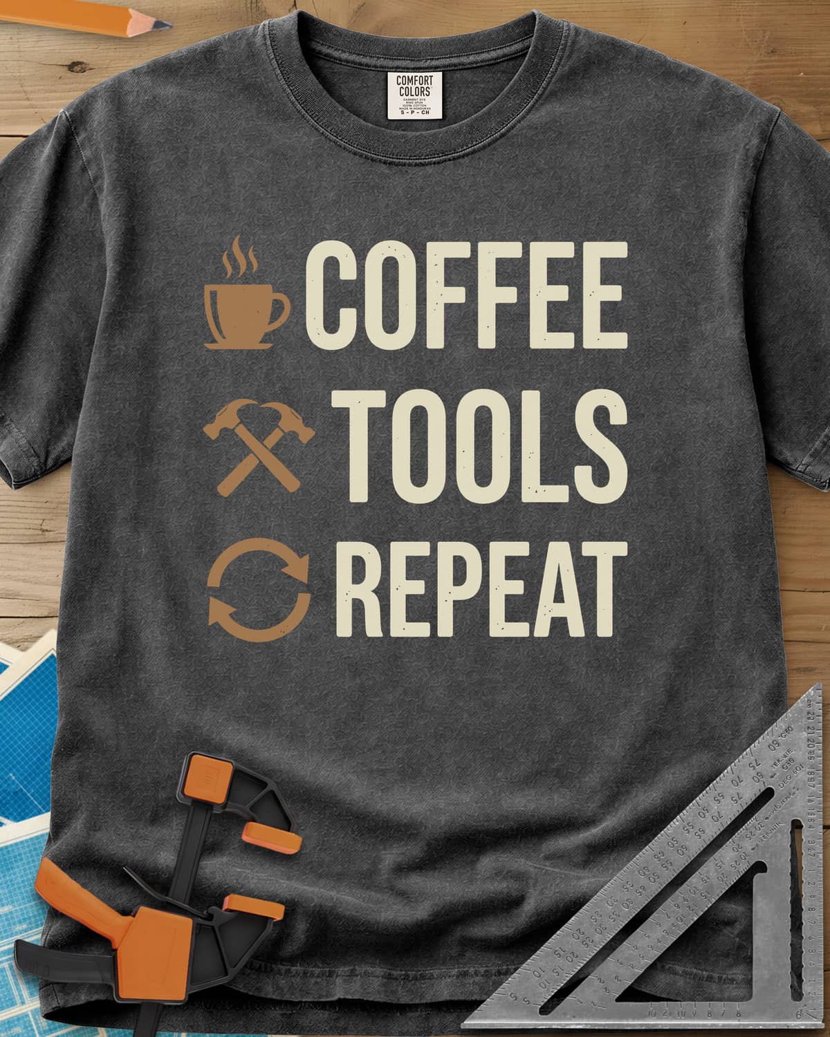 Coffee Tools Repeat heavyweight tee in Pepper, a steaming cup, crossed hammers and loop arrows beside the words