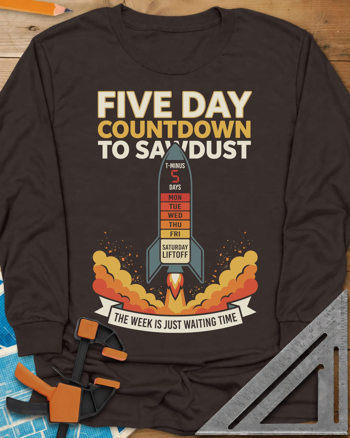 Countdown to Sawdust long sleeve shirt in Dark Chocolate, a rocket with a Monday-to-Saturday countdown on its hull