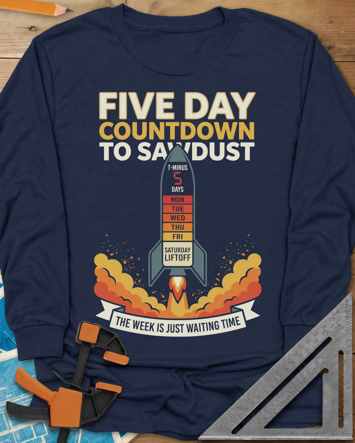 Countdown to Sawdust long sleeve shirt in Navy, a rocket with a Monday-to-Saturday countdown on its hull