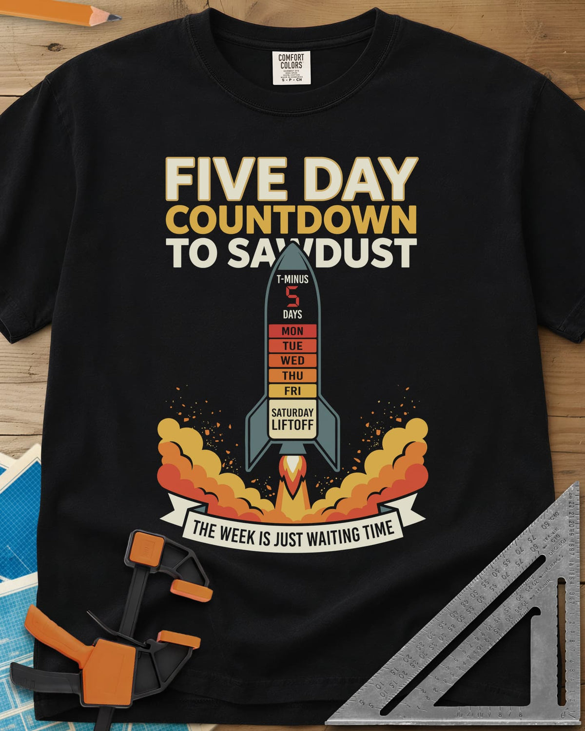 Countdown to Sawdust heavyweight tee in Black, a rocket with a Monday-to-Saturday countdown on its hull