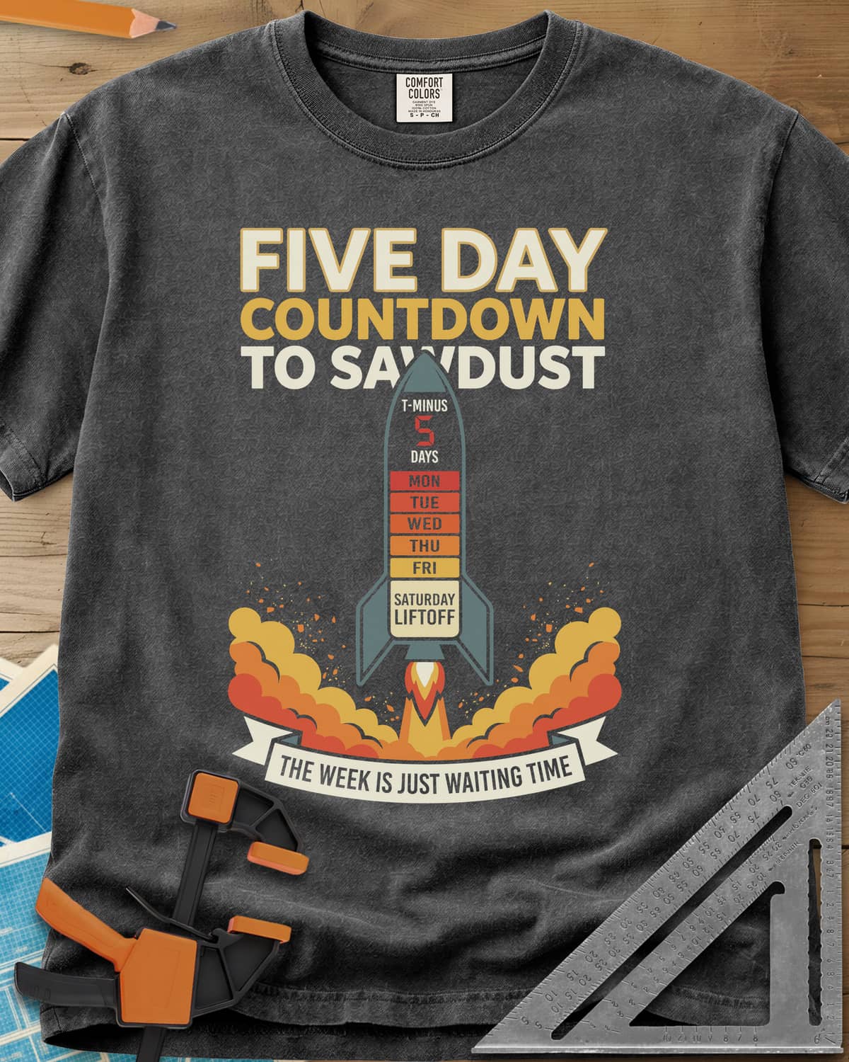 Countdown to Sawdust heavyweight tee in Pepper, a rocket with a Monday-to-Saturday countdown on its hull