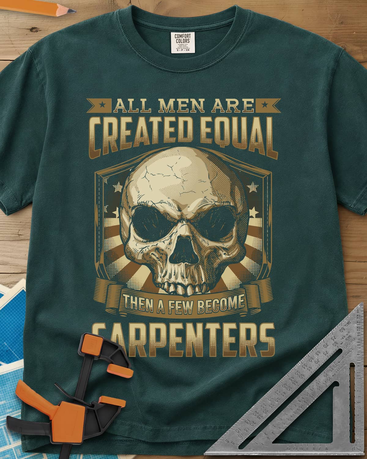 Created Equal Carpenter heavyweight tee in Blue Spruce, a cracked skull on a shield with stars and sunburst rays