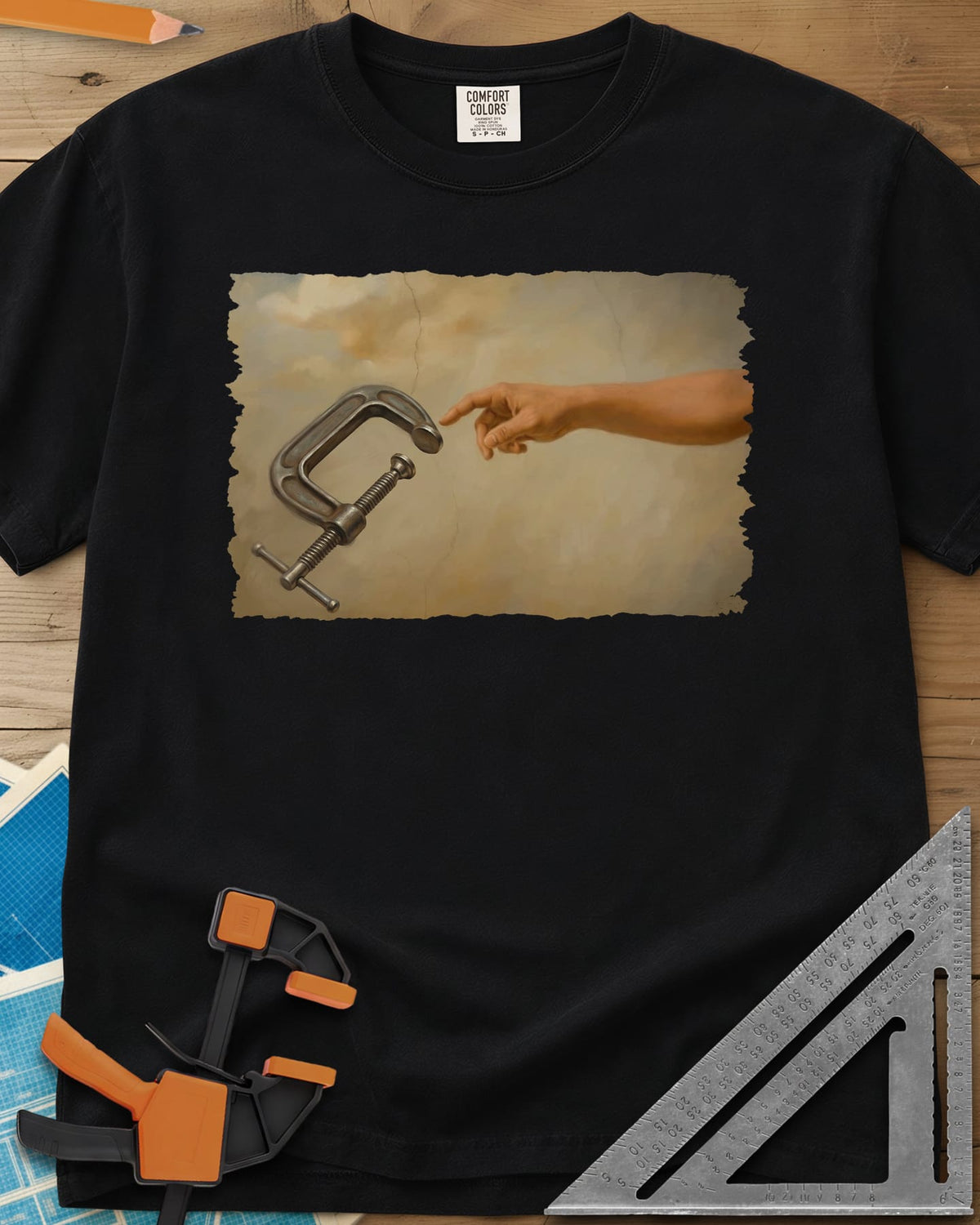 Creation Of The Clamp Woodworking heavyweight tee in Black, a hand reaching for a C-clamp in an aged fresco style