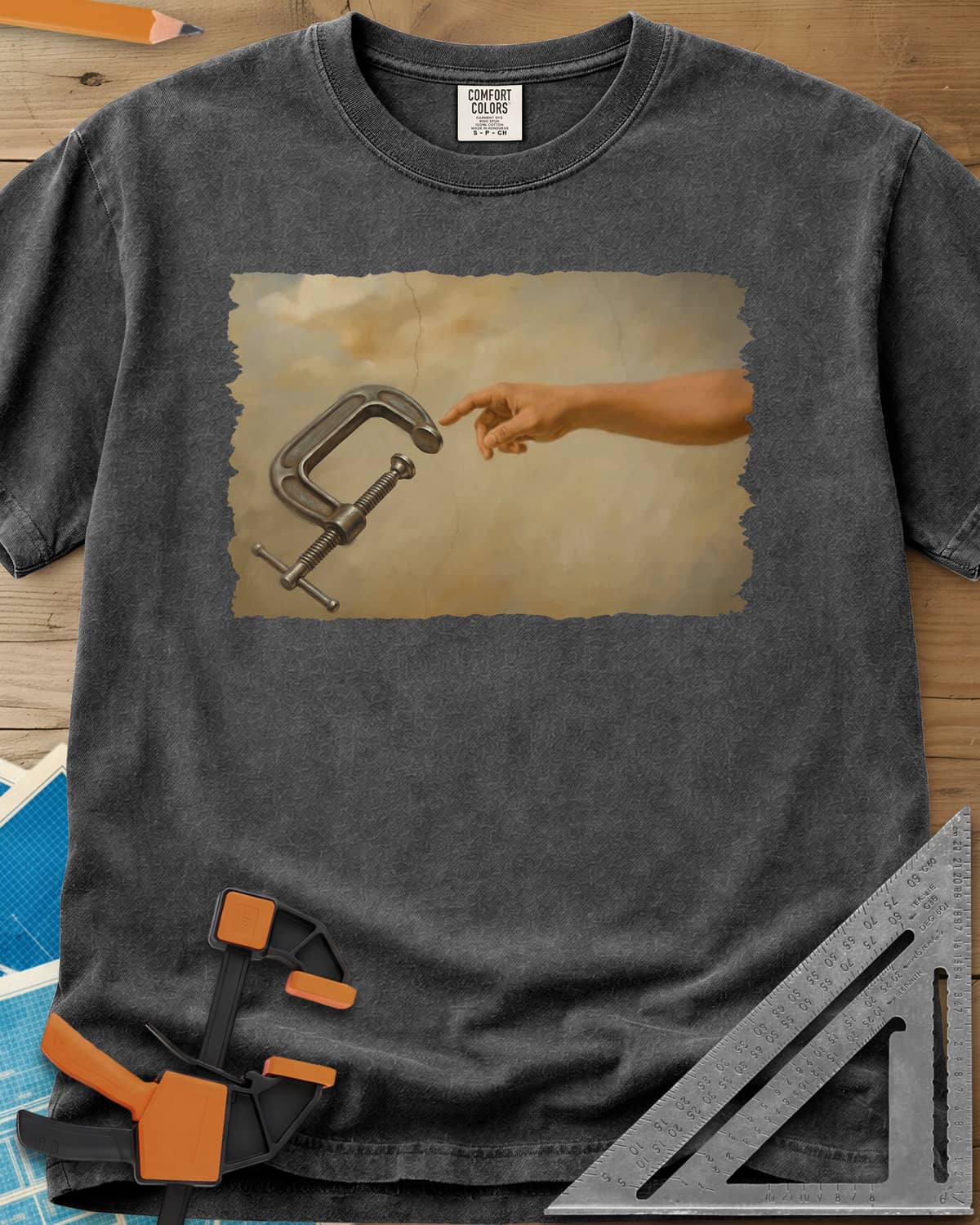 Creation Of The Clamp Woodworking heavyweight tee in Pepper, a hand reaching for a C-clamp in an aged fresco style