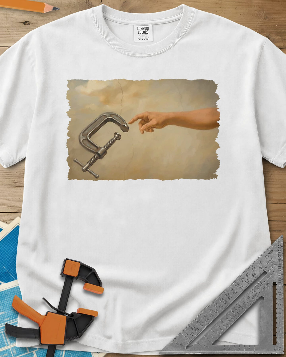 Creation Of The Clamp Woodworking heavyweight tee in White, a hand reaching for a C-clamp in an aged fresco style