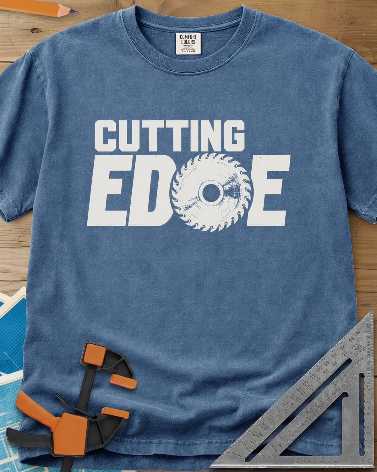 Cutting Edge heavyweight tee in Blue Jean, bold lettering with a circular saw blade standing in for the G