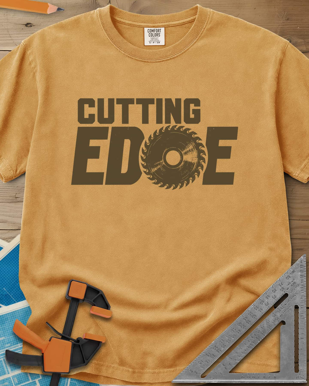 Cutting Edge heavyweight tee in Mustard, bold lettering with a circular saw blade standing in for the G