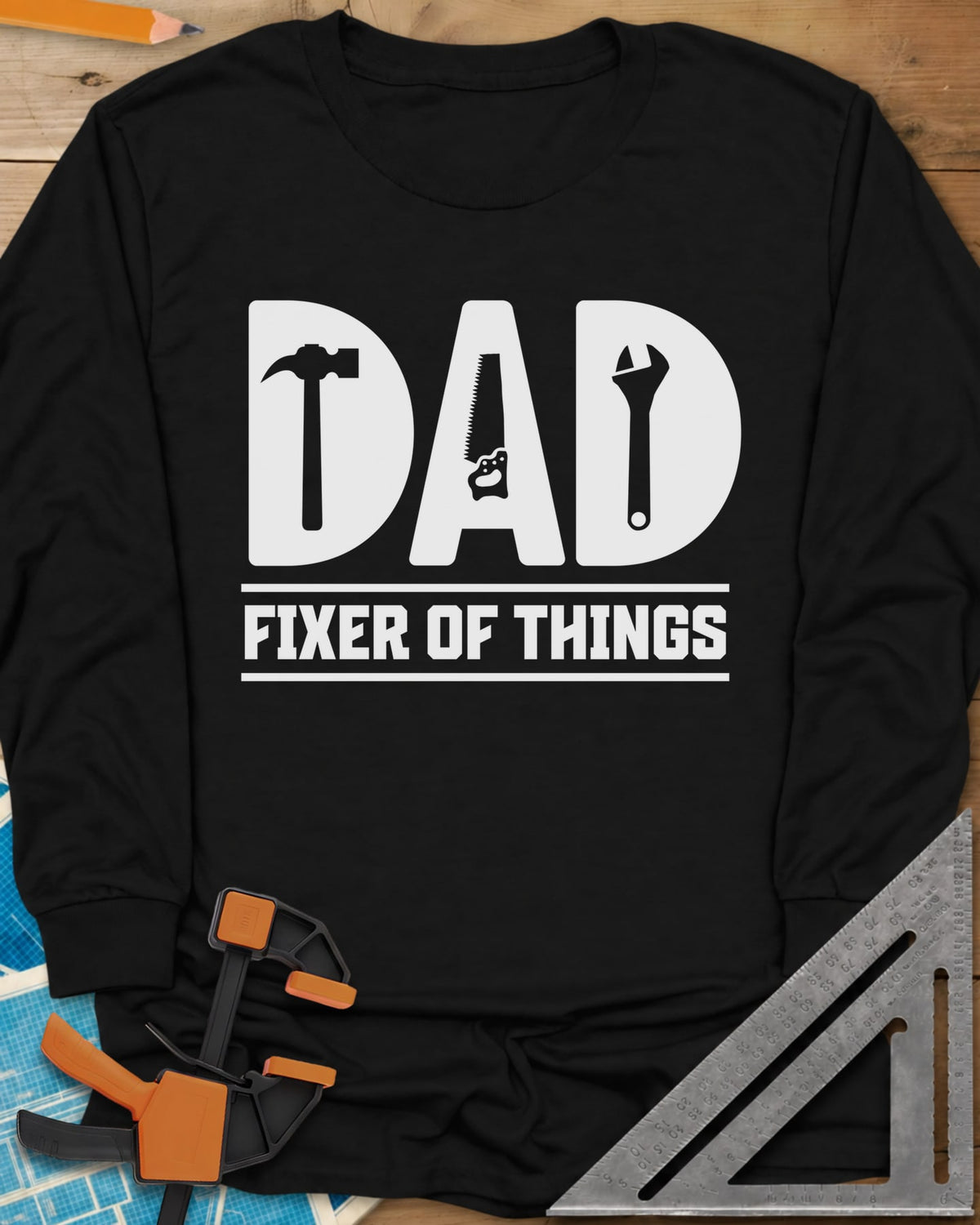 Dad, Fixer of All Things long sleeve shirt in Black, big letters spelling DAD with a hammer, saw and wrench cut in
