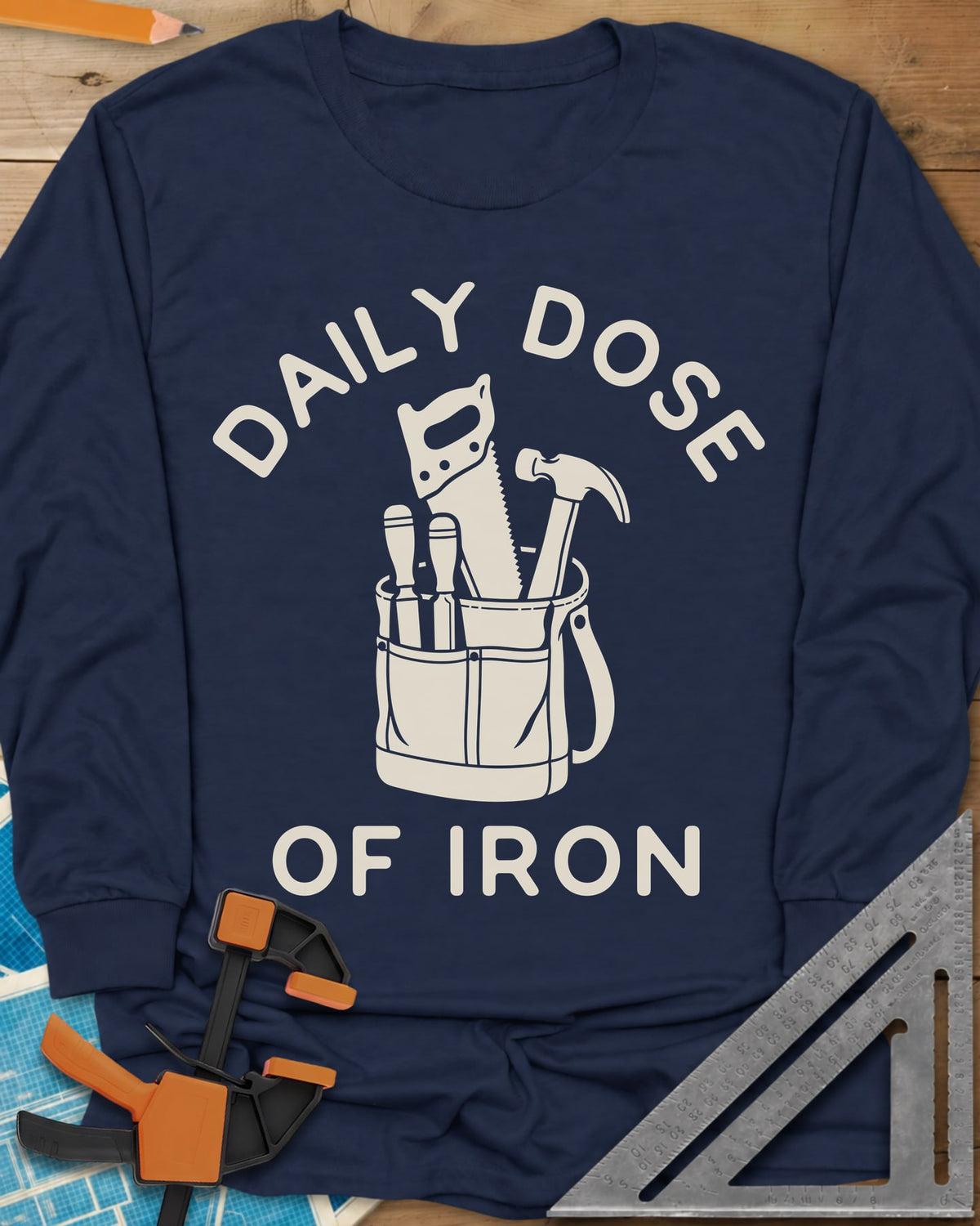 Daily Dose long sleeve shirt in Navy, a canvas tool bag holding a handsaw, hammer and two chisels