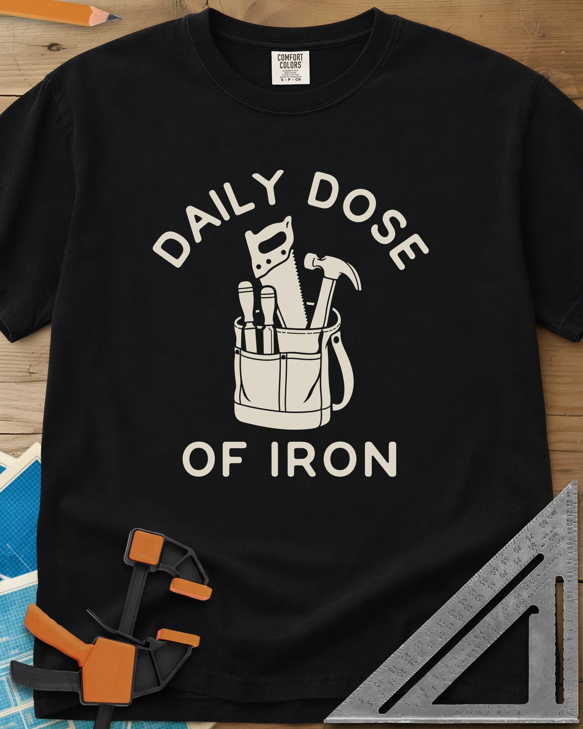 Daily Dose heavyweight tee in Black, a canvas tool bag holding a handsaw, hammer and two chisels