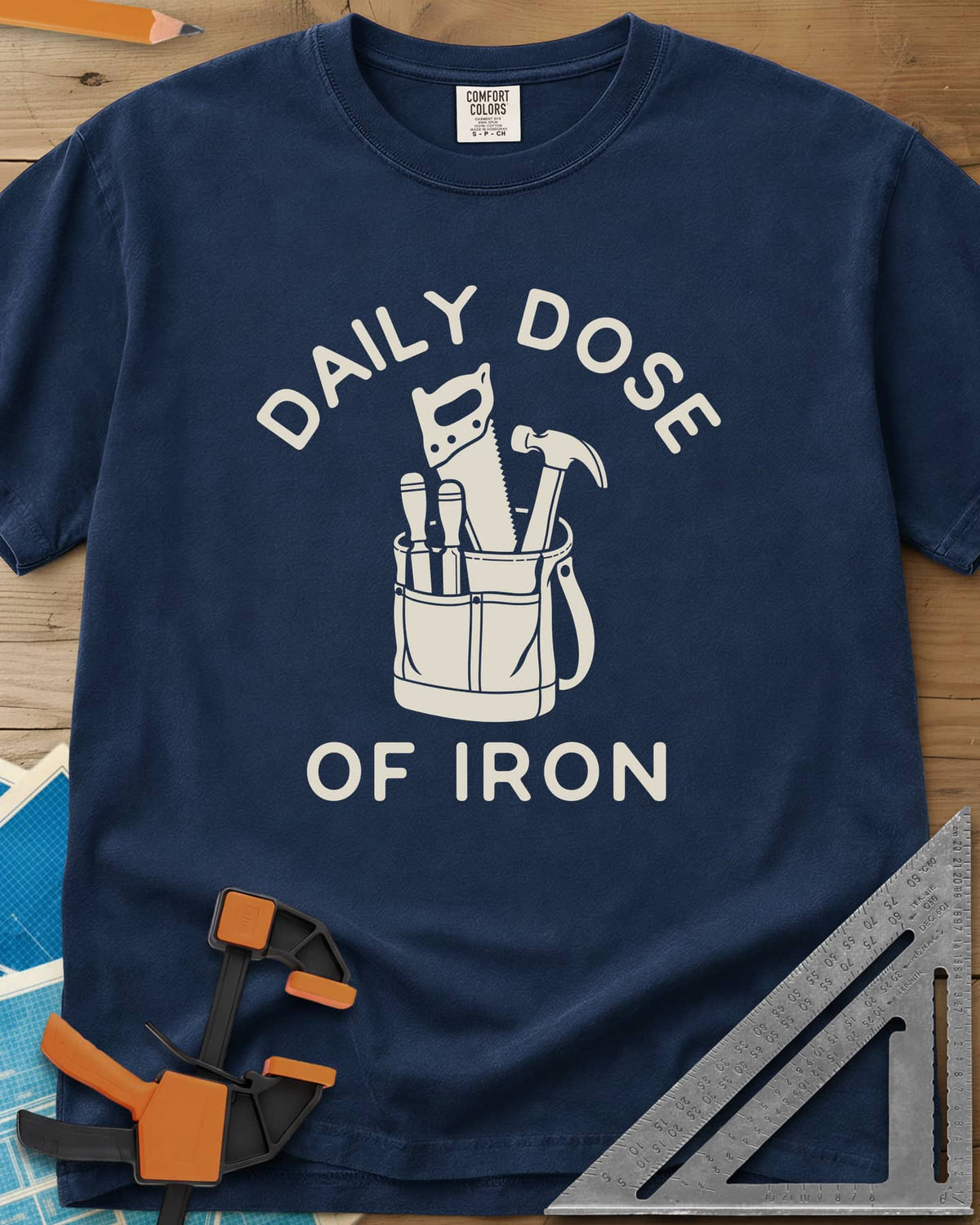 Daily Dose heavyweight tee in Navy, a canvas tool bag holding a handsaw, hammer and two chisels
