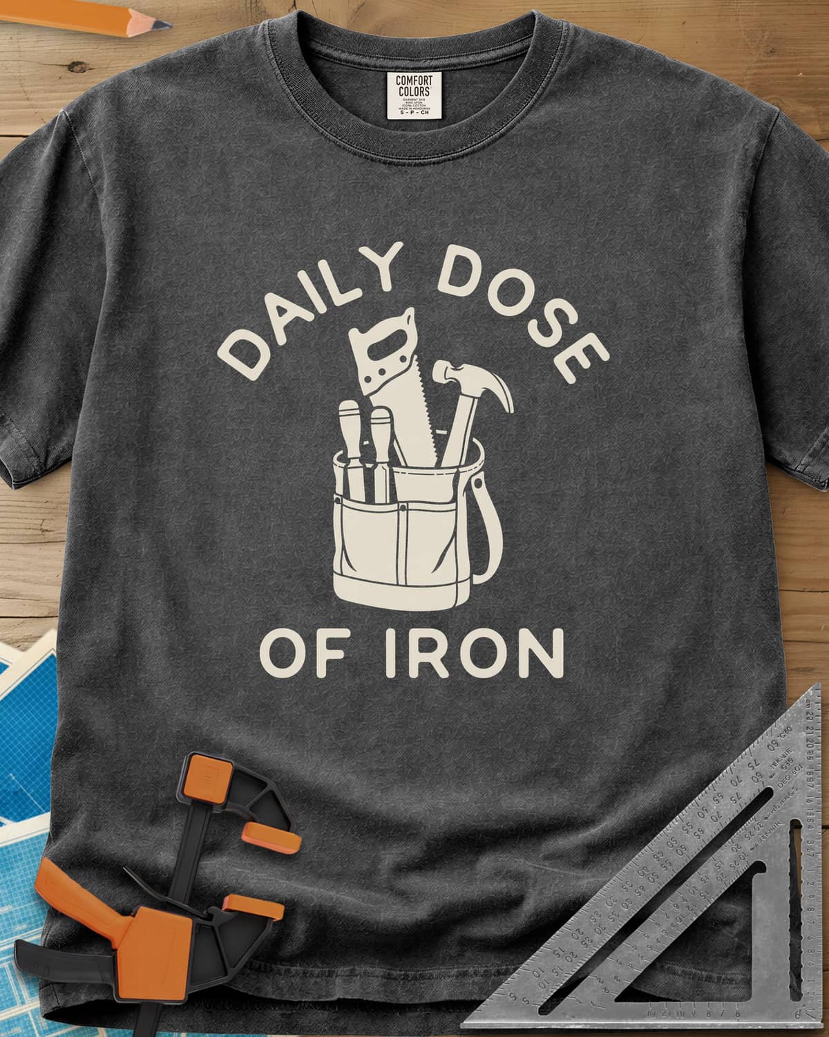 Daily Dose heavyweight tee in Pepper, a canvas tool bag holding a handsaw, hammer and two chisels