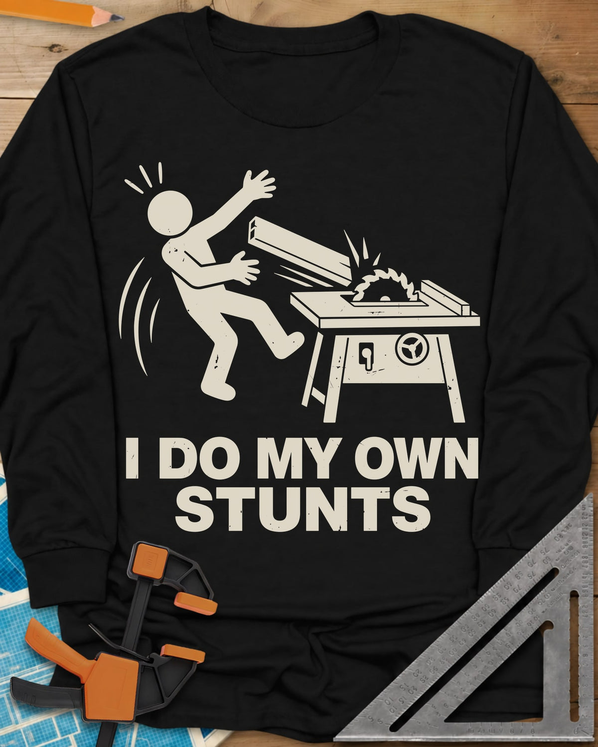 DIY Stunts long sleeve shirt in Black, a stick figure leaning back as a board flies off a table saw