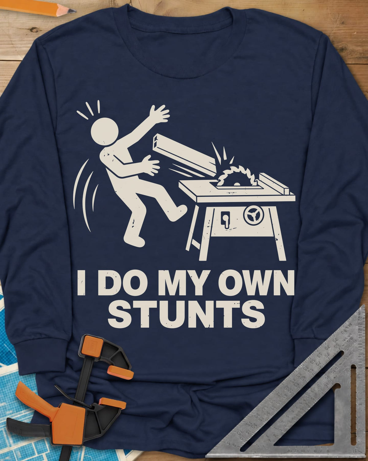 DIY Stunts long sleeve shirt in Navy, a stick figure leaning back as a board flies off a table saw