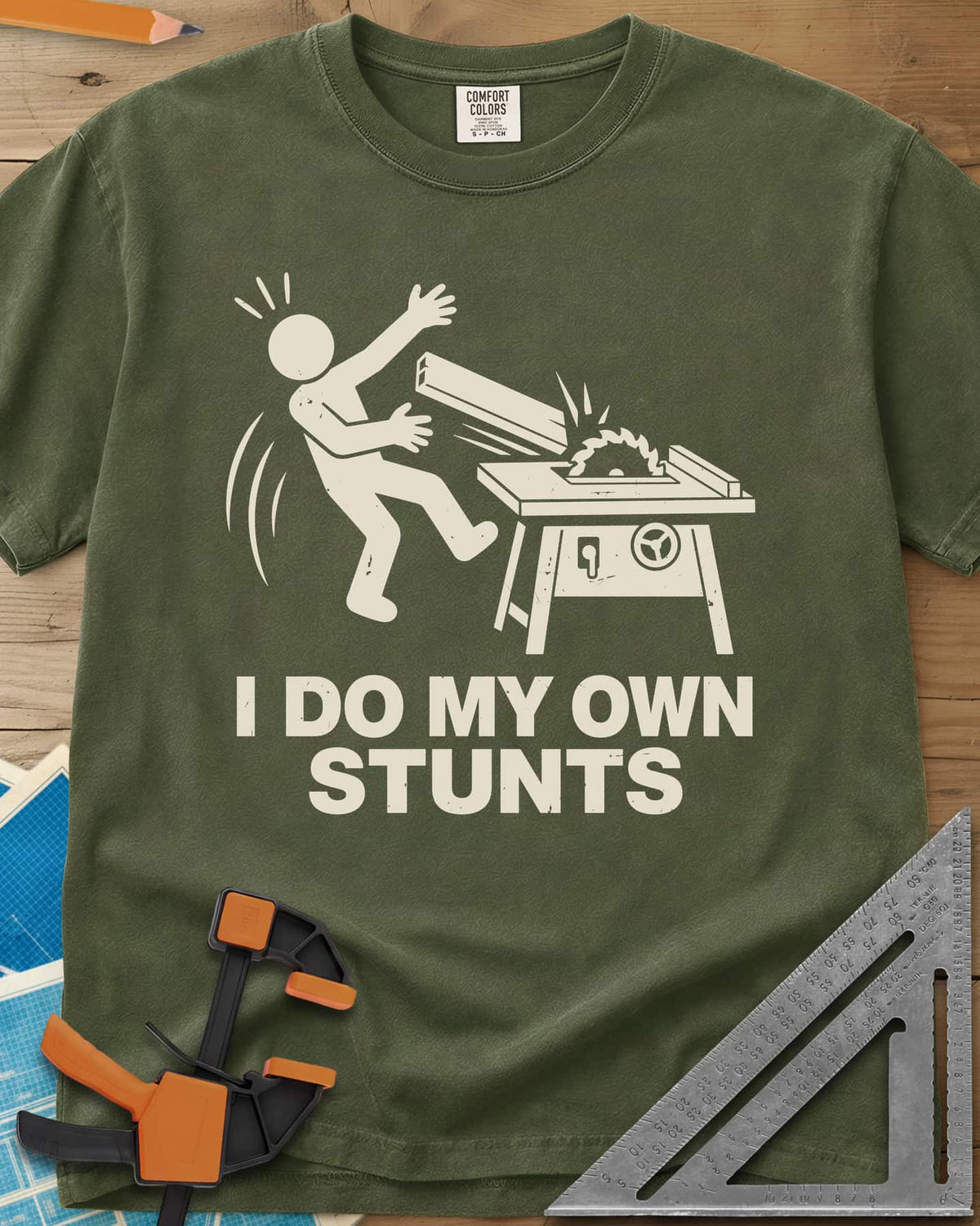DIY Stunts heavyweight tee in Hemp, a stick figure leaning back as a board flies off a table saw