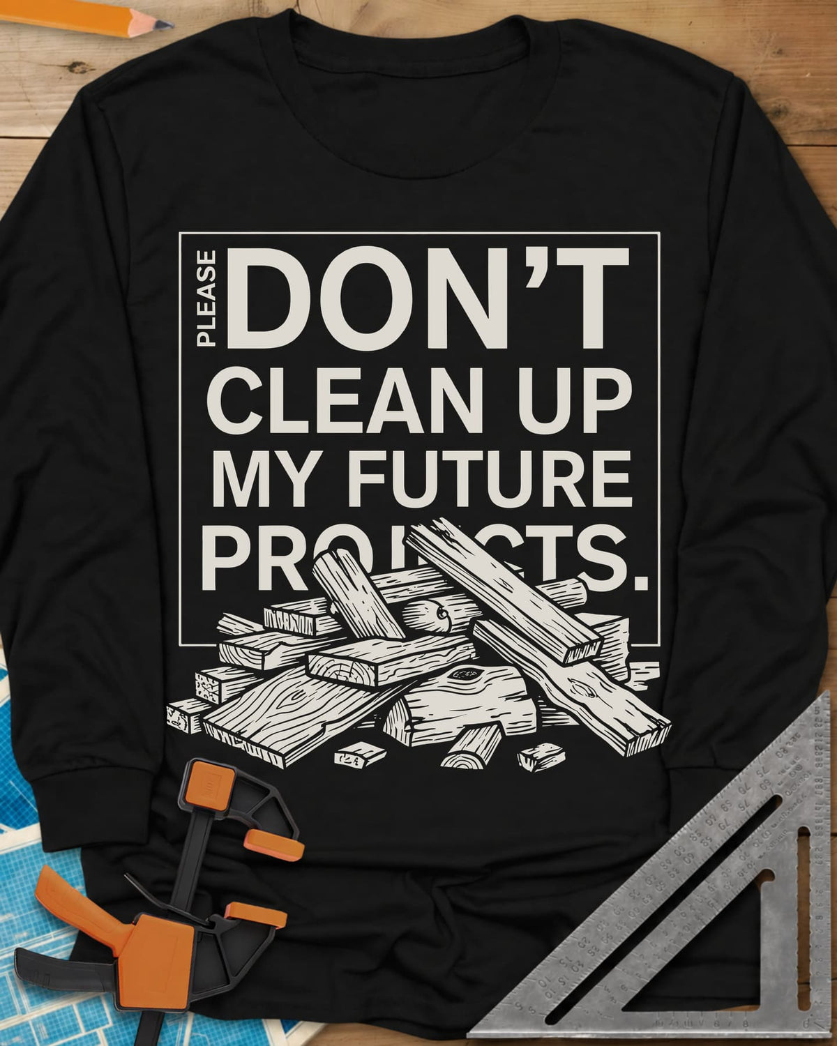 Don't Clean Up My Future Projects long sleeve shirt in Black, a boxed plea with a pile of boards and offcuts below