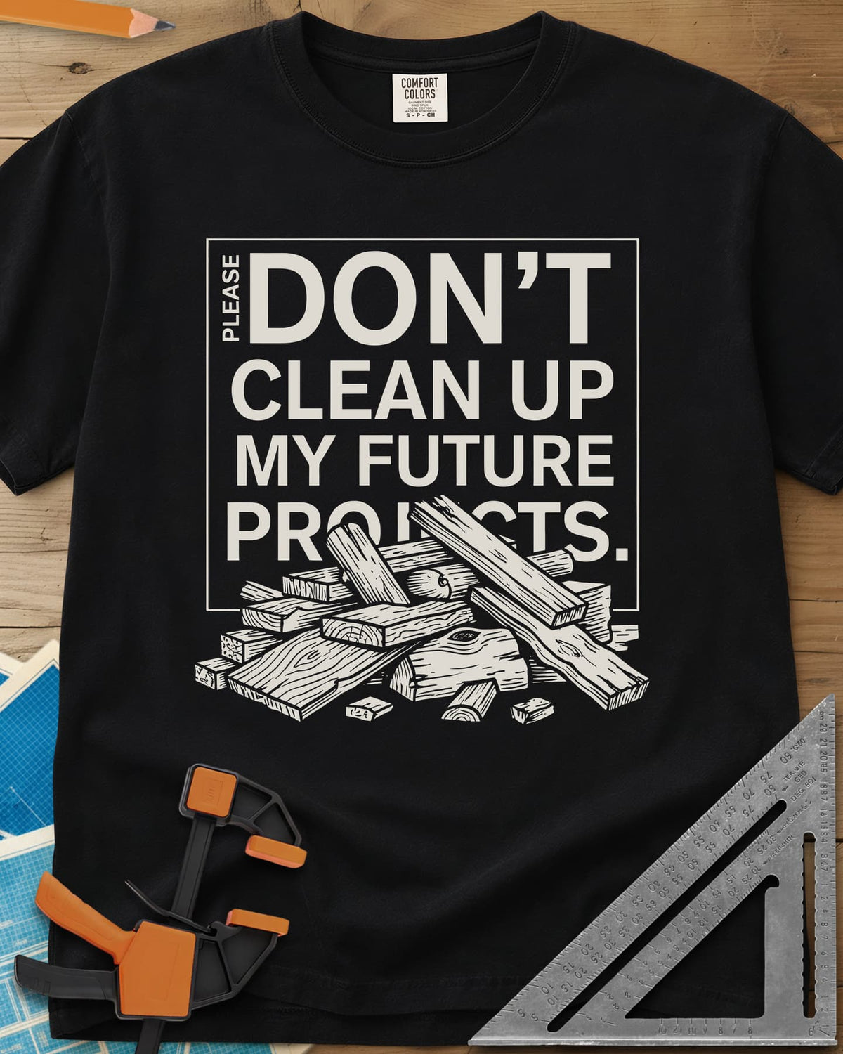 Don't Clean Up My Future Projects heavyweight tee in Black, a boxed plea with a pile of boards and offcuts below