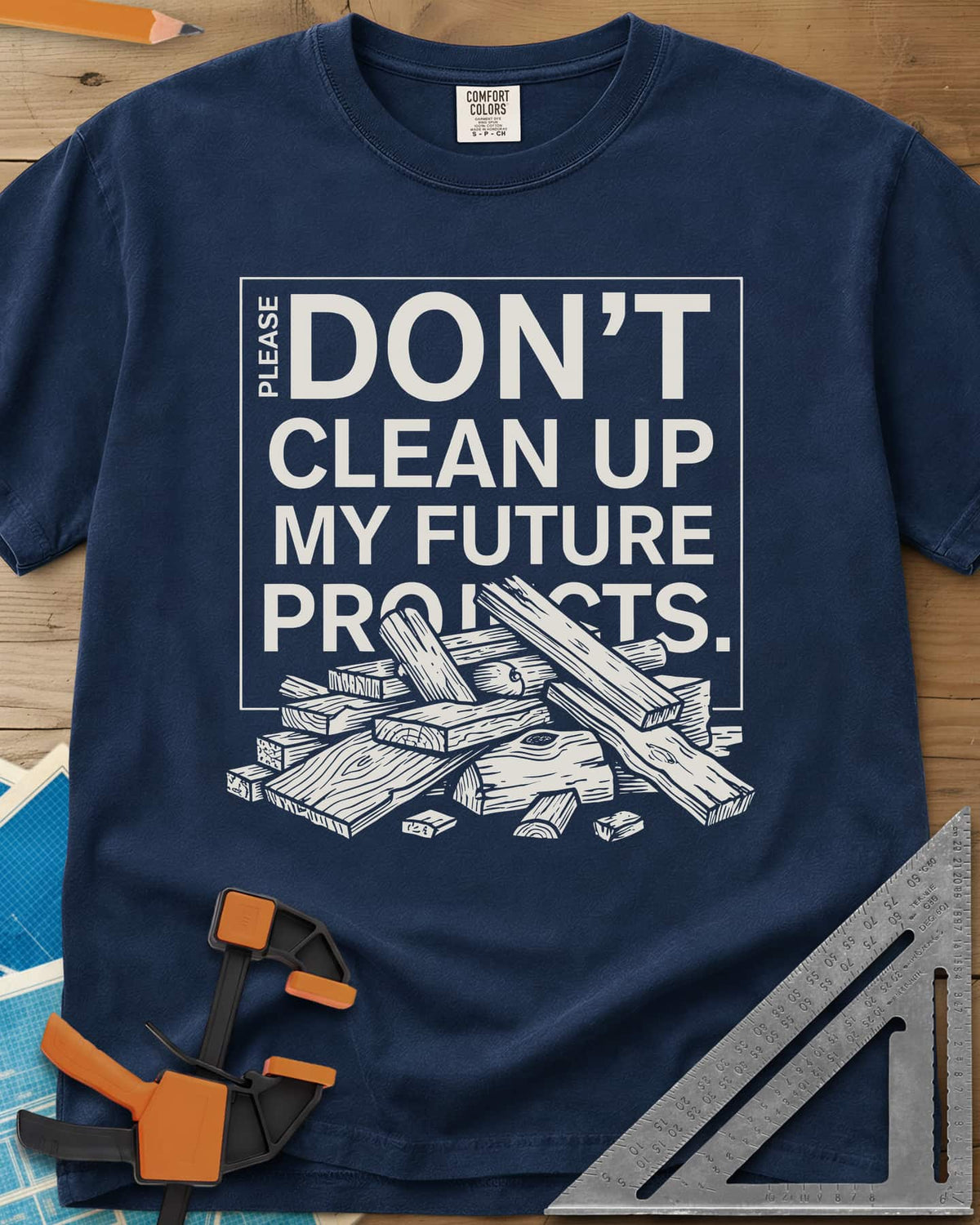 Don't Clean Up My Future Projects heavyweight tee in Navy, a boxed plea with a pile of boards and offcuts below