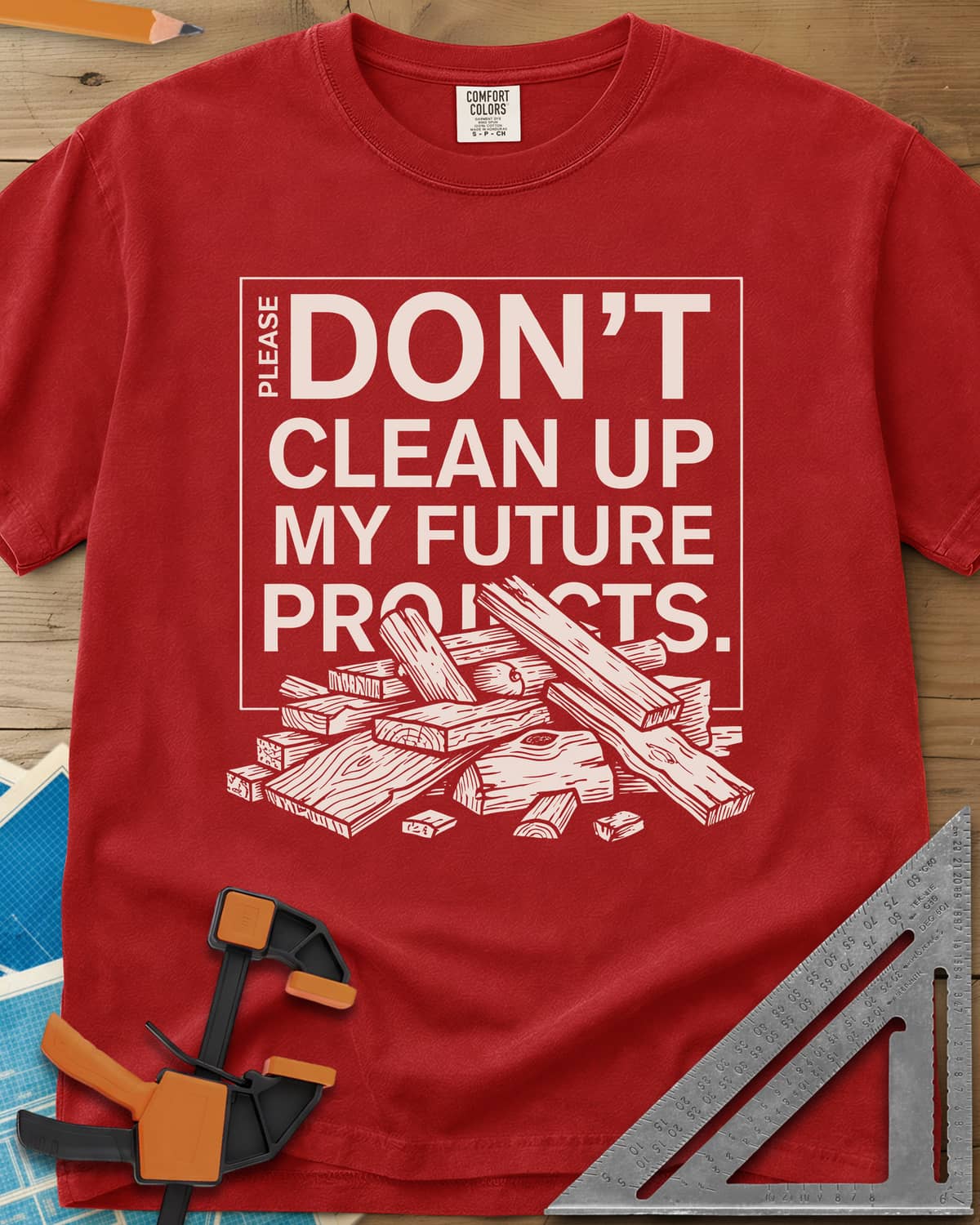 Don't Clean Up My Future Projects heavyweight tee in Red, a boxed plea with a pile of boards and offcuts below