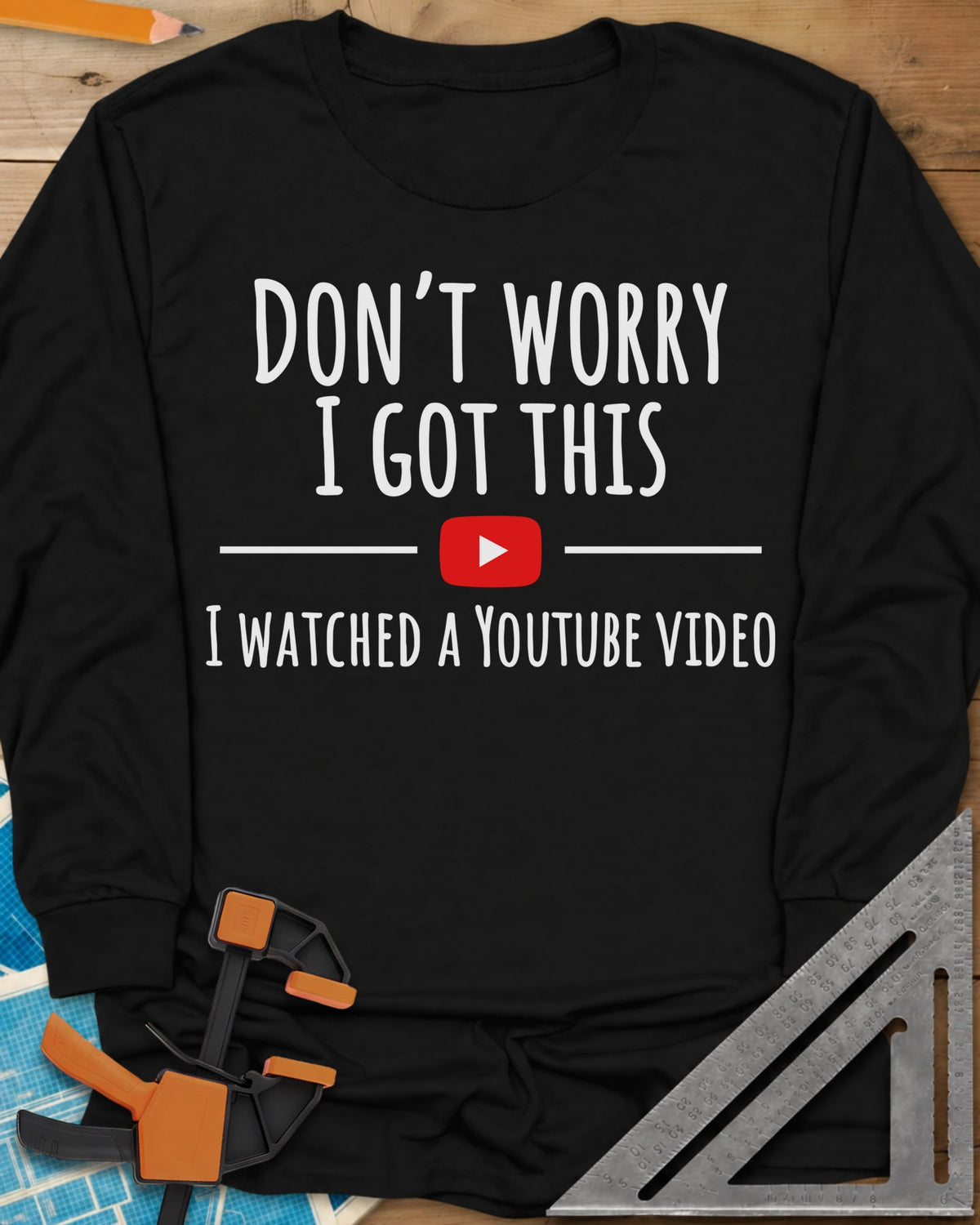 Don't Worry long sleeve shirt in Black, bold lettering split by a red YouTube play button