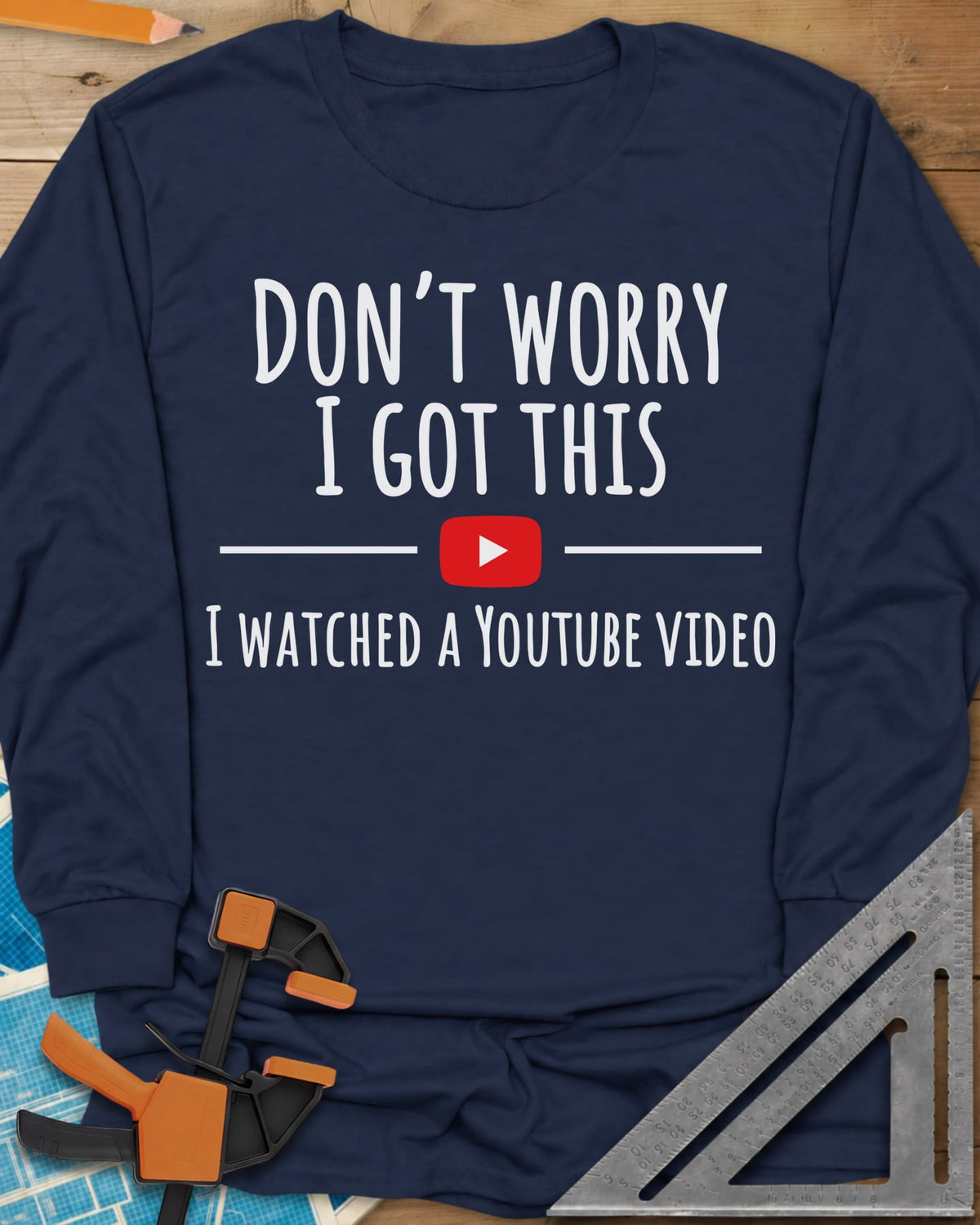 Don't Worry long sleeve shirt in Navy, bold lettering split by a red YouTube play button