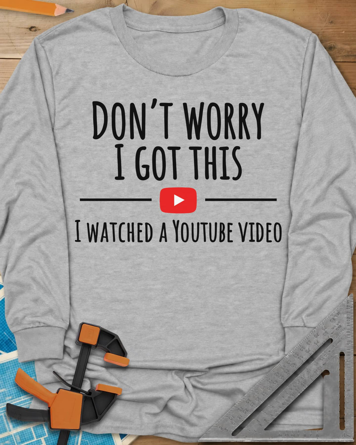 Don't Worry long sleeve shirt in Sport Grey, bold lettering split by a red YouTube play button