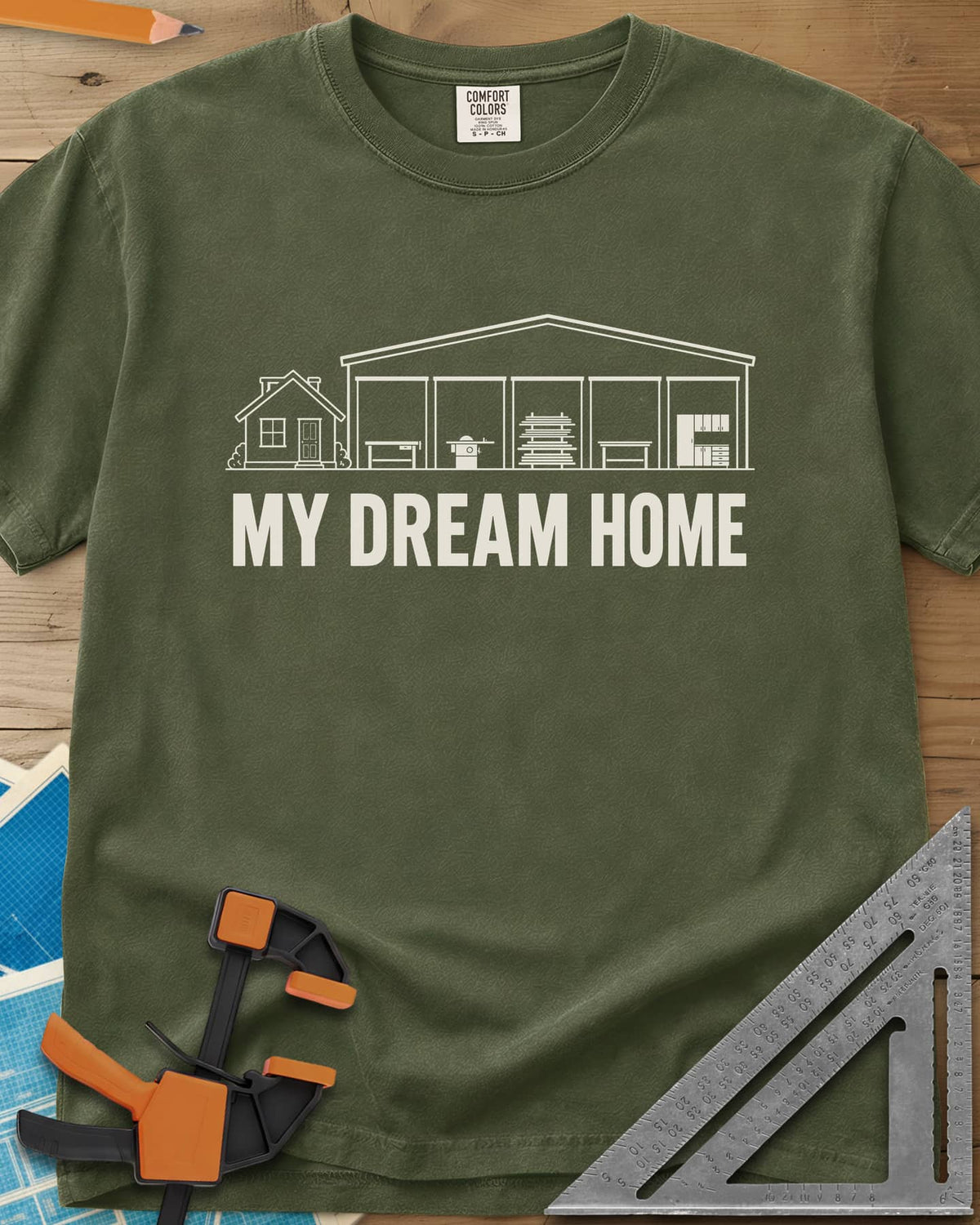 Dream Home heavyweight tee in Hemp, a small house beside a huge five-bay woodworking shop