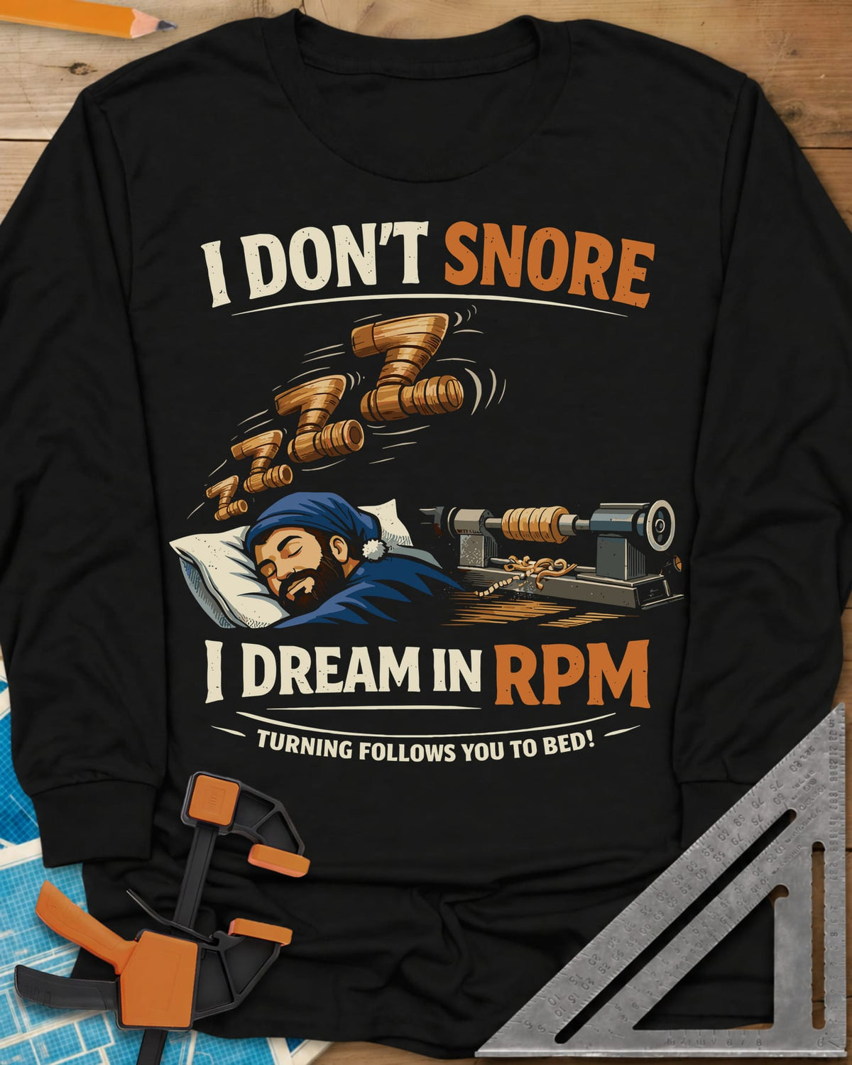 Dream in RPM long sleeve shirt in Black, a sleeping woodturner in a nightcap, wooden Zs and a lathe
