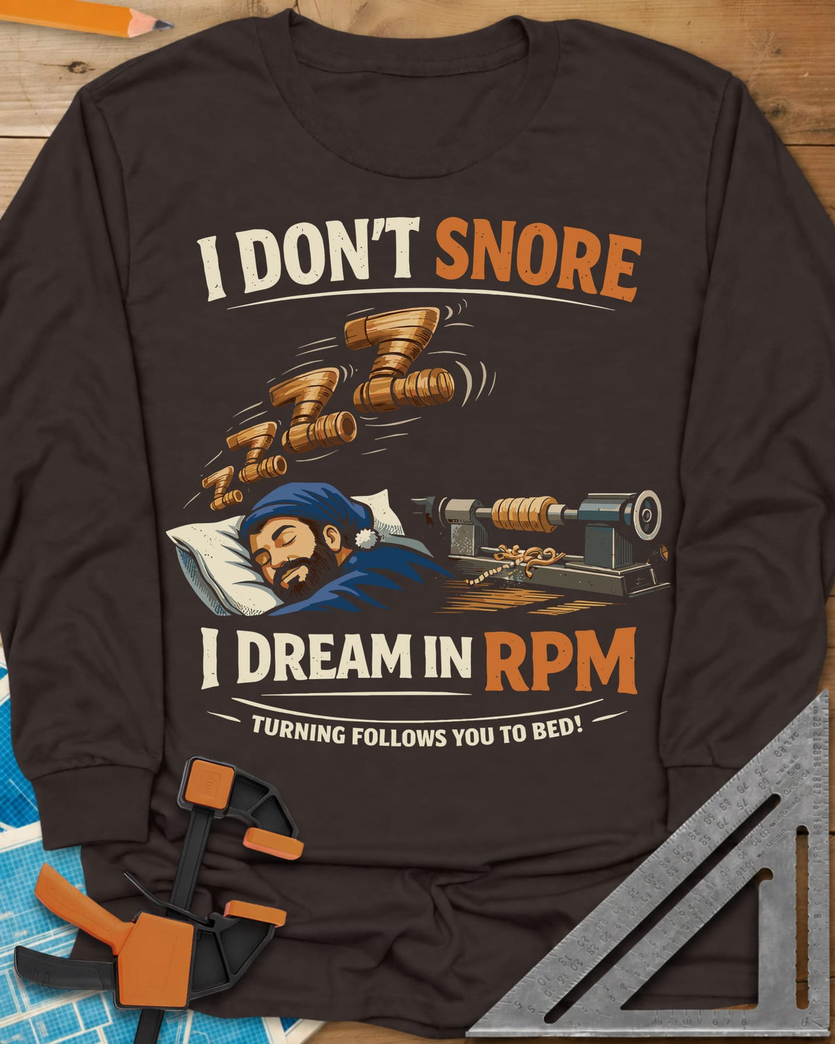 Dream in RPM long sleeve shirt in Dark Chocolate, a sleeping woodturner in a nightcap, wooden Zs and a lathe