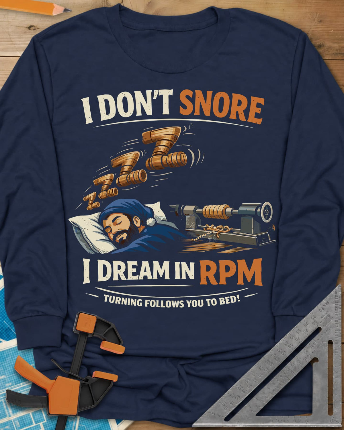 Dream in RPM long sleeve shirt in Navy, a sleeping woodturner in a nightcap, wooden Zs and a lathe